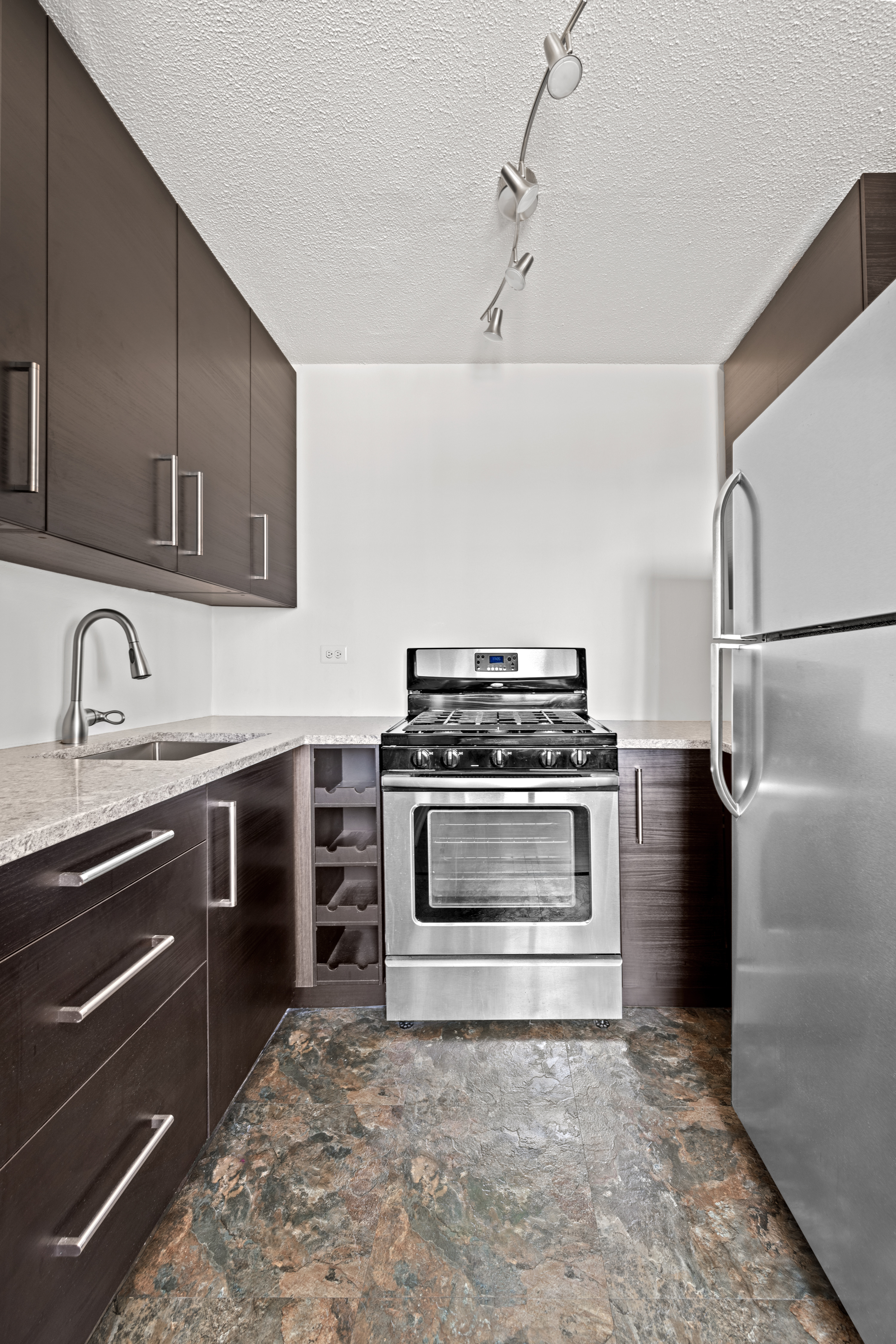 90 Gold Street, Unit 21G Manhattan, NY 10038 - Photo 4 of 9 a kitchen with a stove and a sink