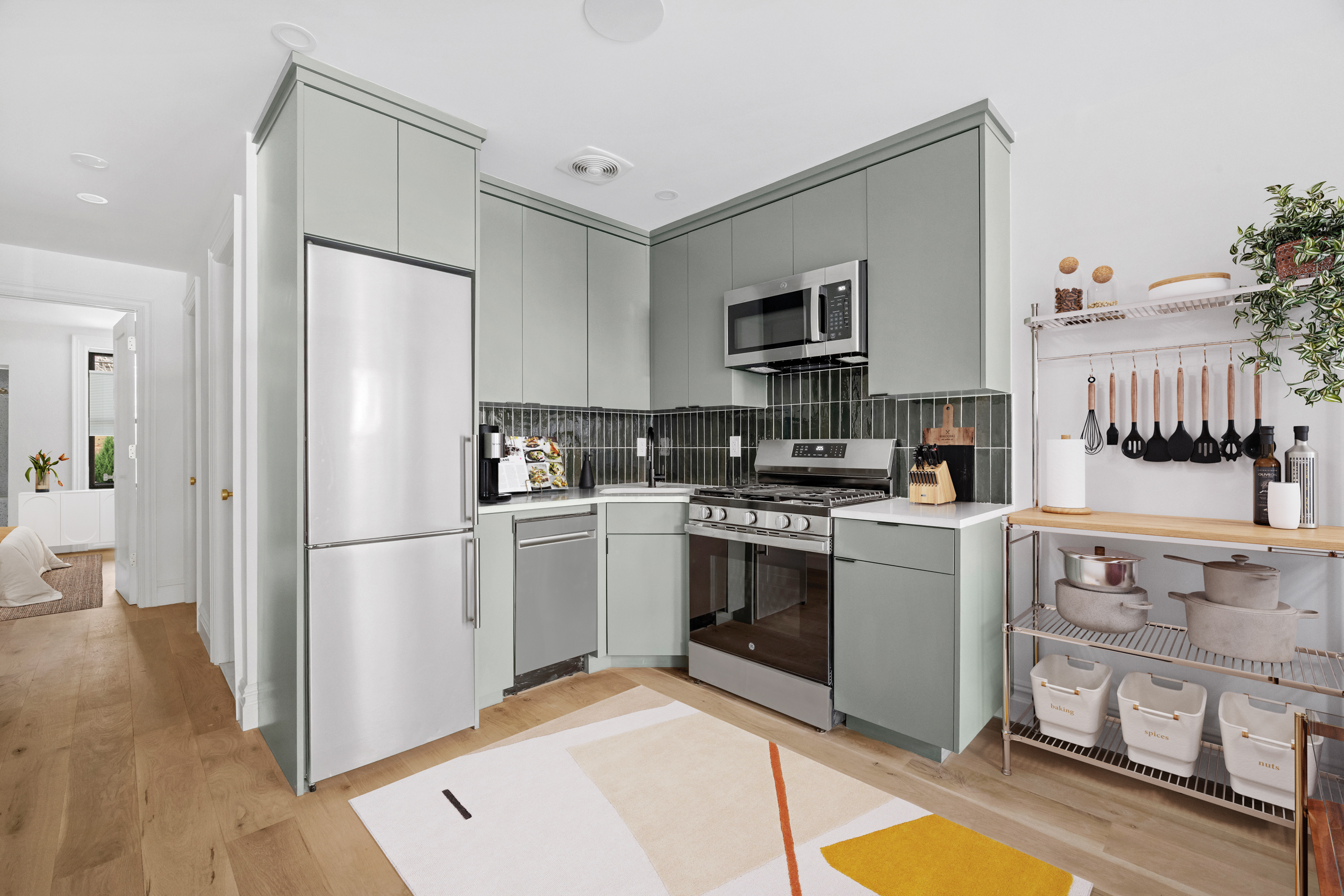 544 Madison Street, Unit A Brooklyn, NY 11221 - Photo 7 of 17 a kitchen with stainless steel appliances a refrigerator stove microwave and sink