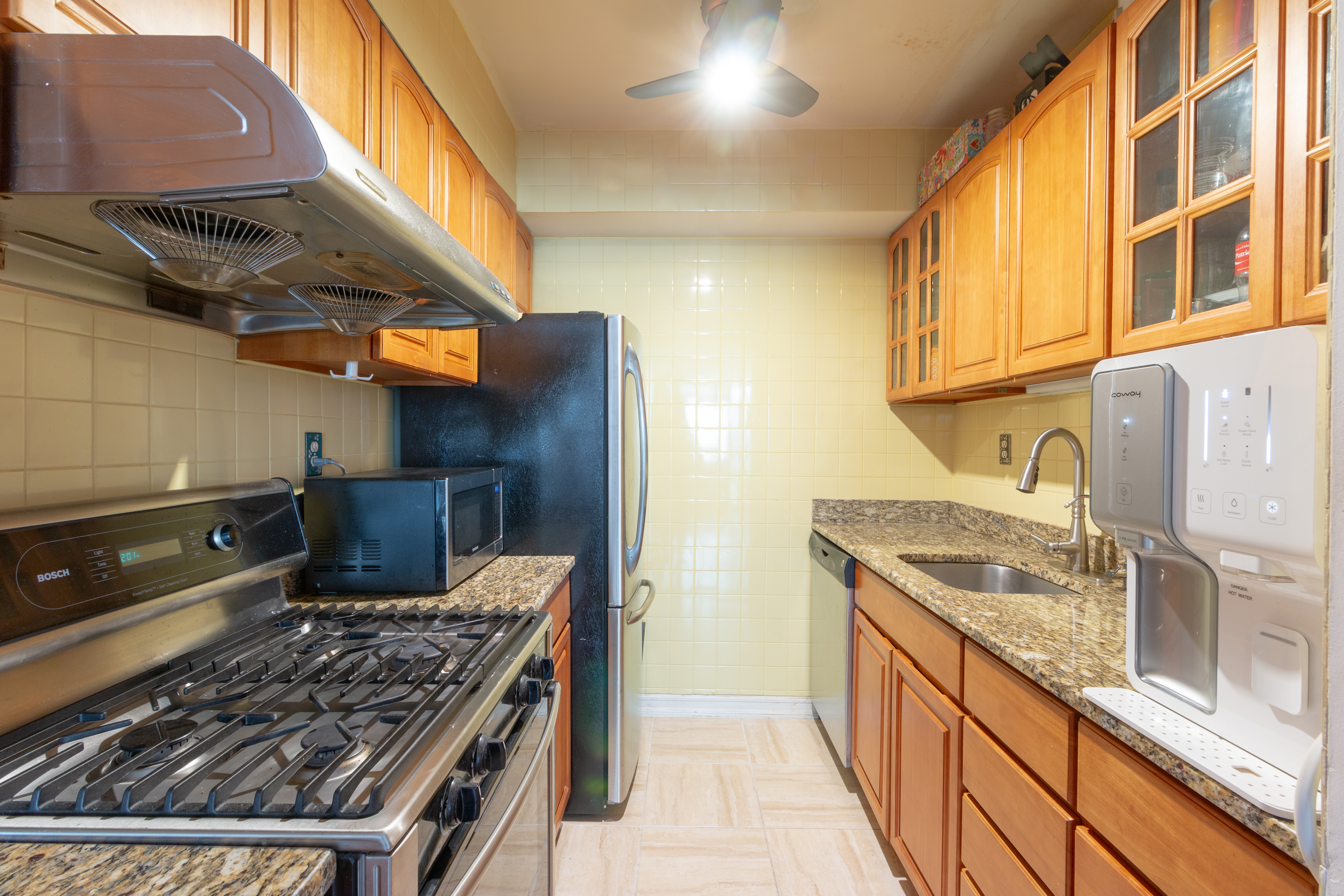 108 5th Avenue, Unit 15C Manhattan, NY 10011 - Photo 6 of 12 a kitchen with stainless steel appliances granite countertop a sink and a stove