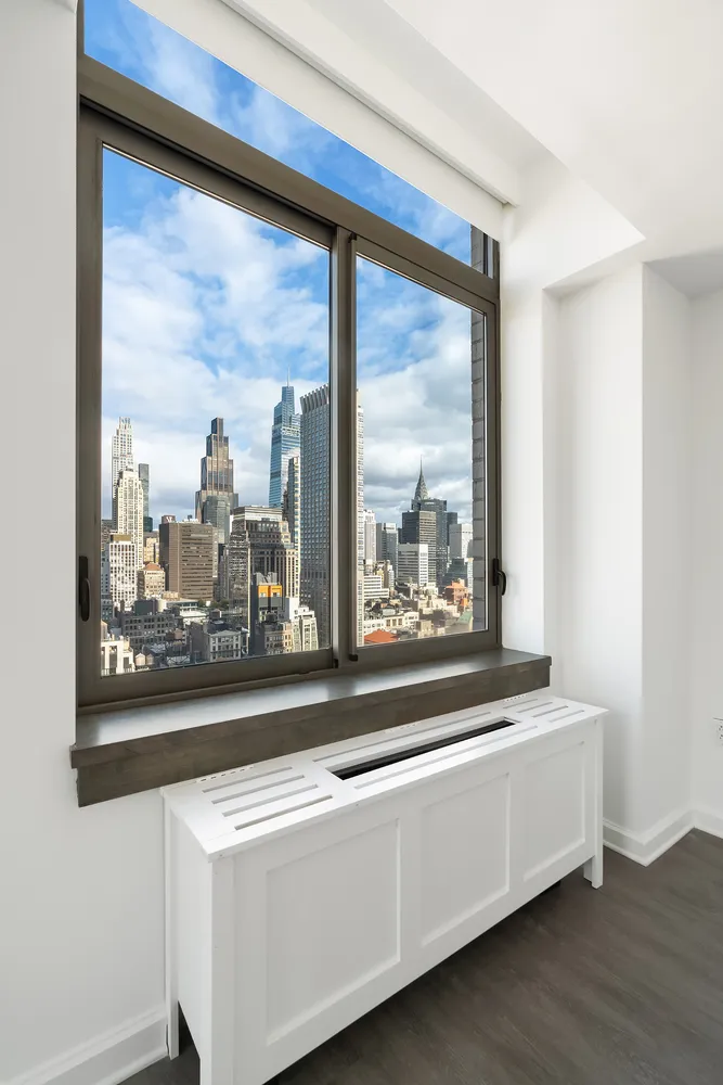 a view of a room with a large window and front door