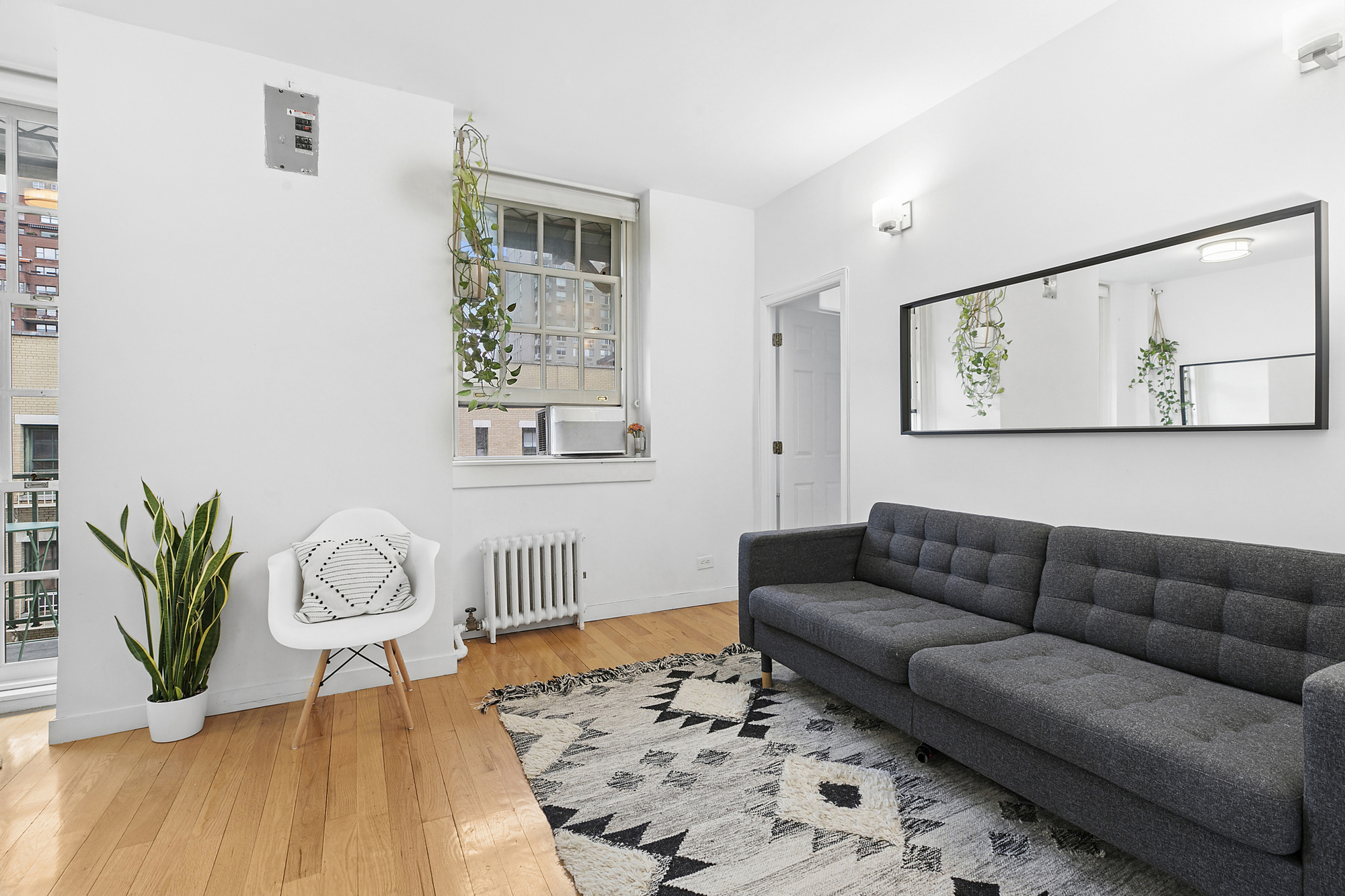 508 East 78th Street, Unit 6O Manhattan, NY 10075 - Photo 2 of 11 a living room with furniture rug and wooden floor
