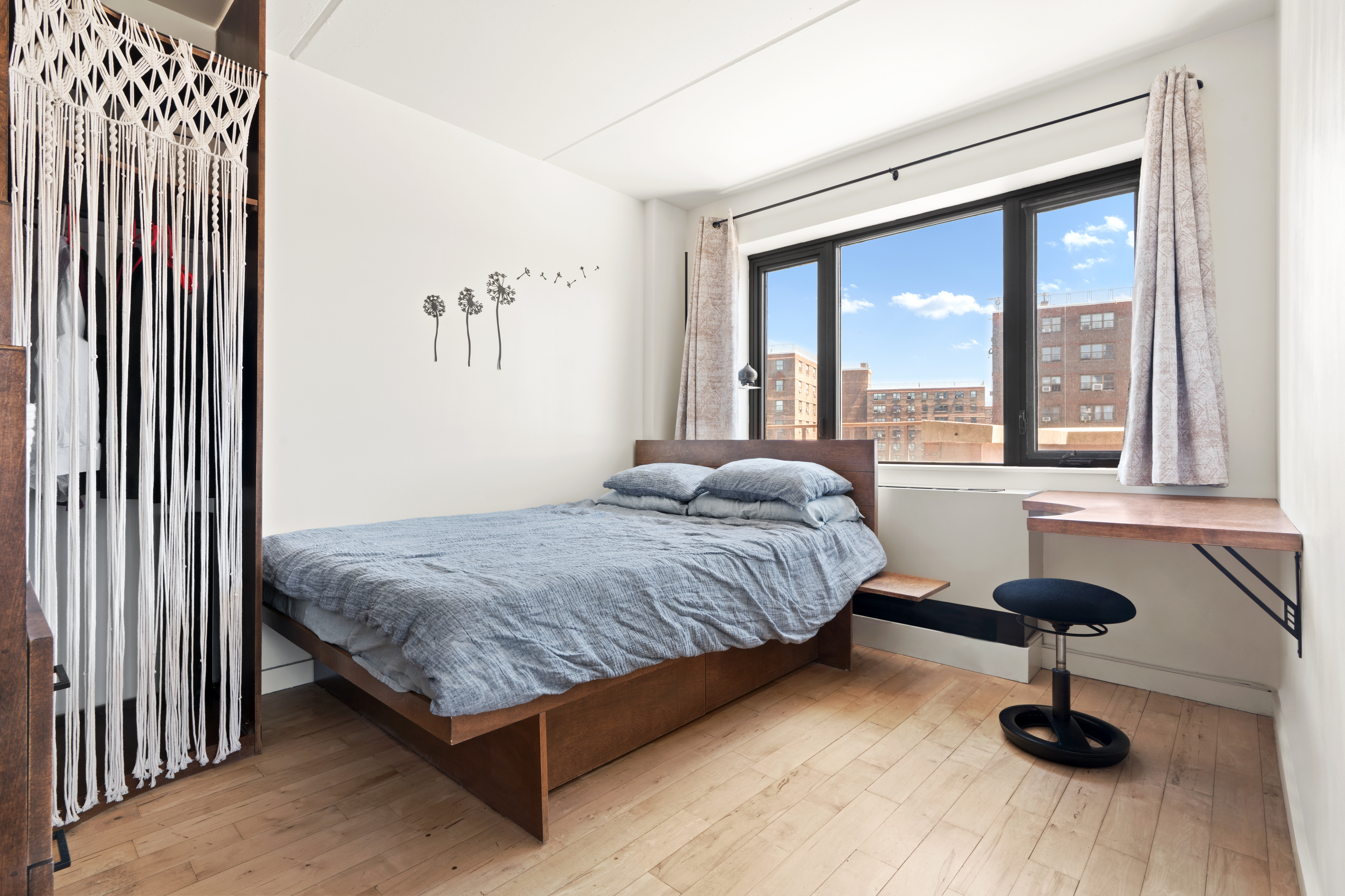 1810 3rd Avenue, Unit 9D Manhattan, NY 10029 - Photo 4 of 10 a bedroom with a bed and a large window