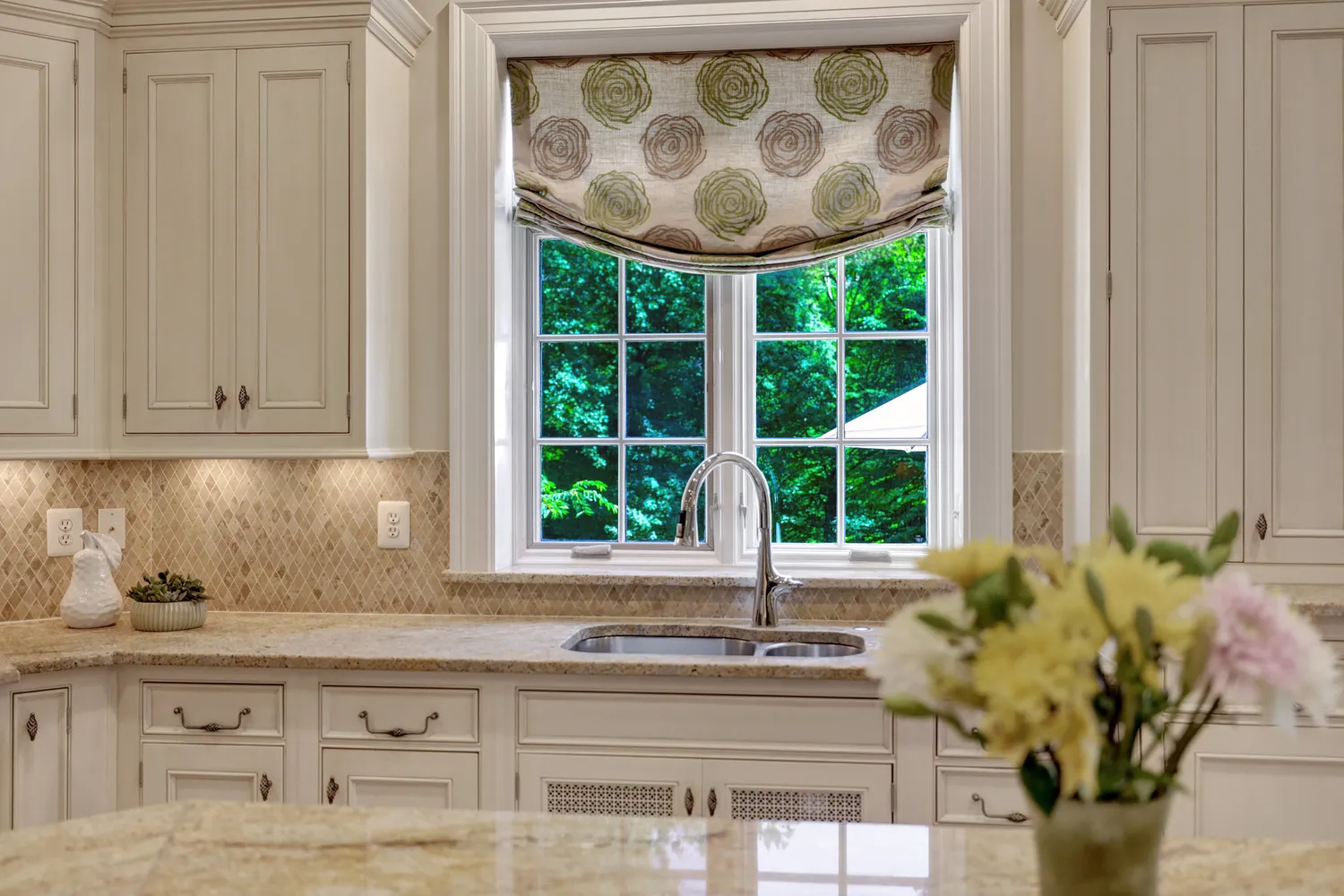 a bed sitting in a spacious bedroom next to a window
