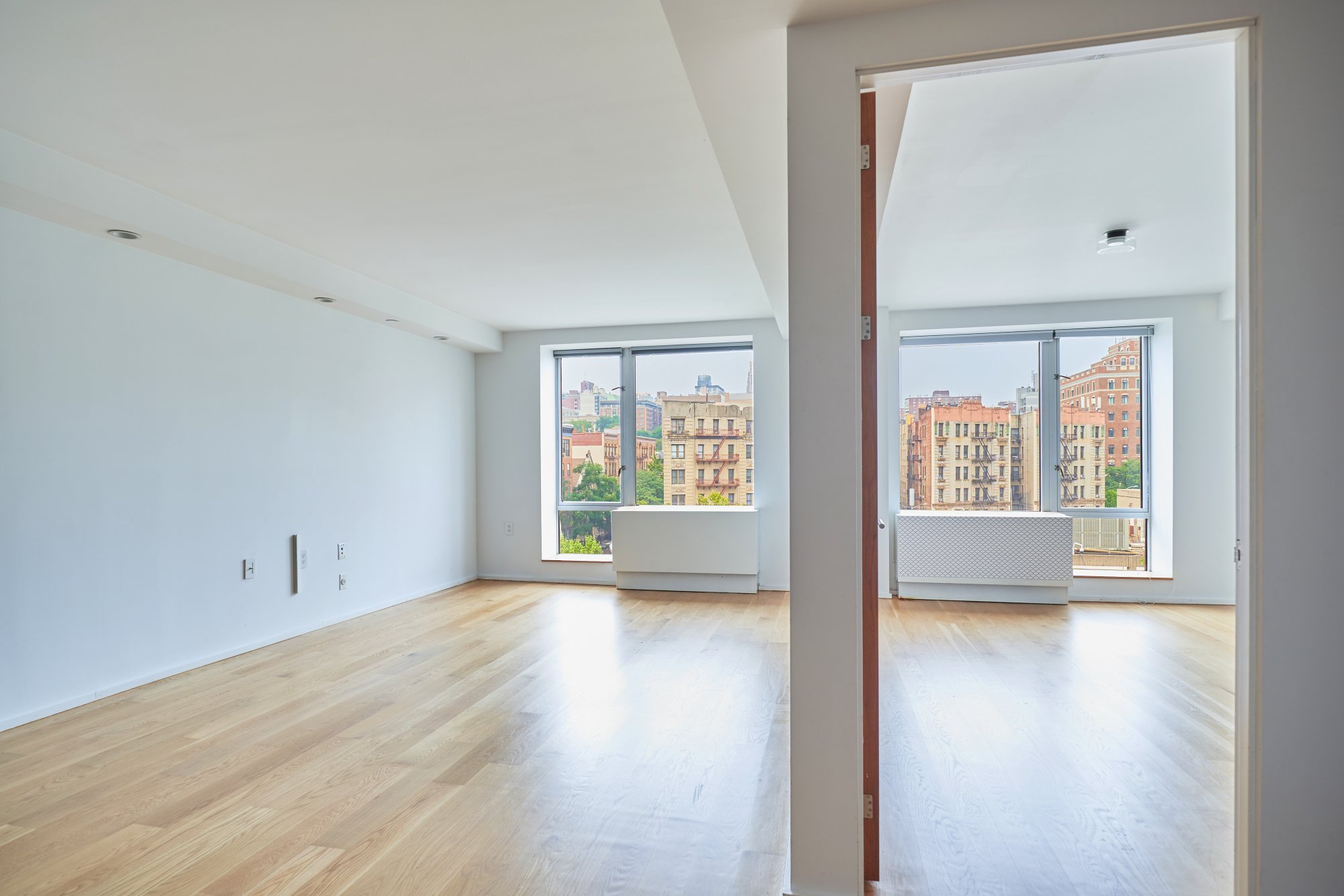 2280 Frederick Douglass Boulevard, Unit 5D Manhattan, NY 10027 - Photo 7 of 22 wooden floor in an empty room with a window