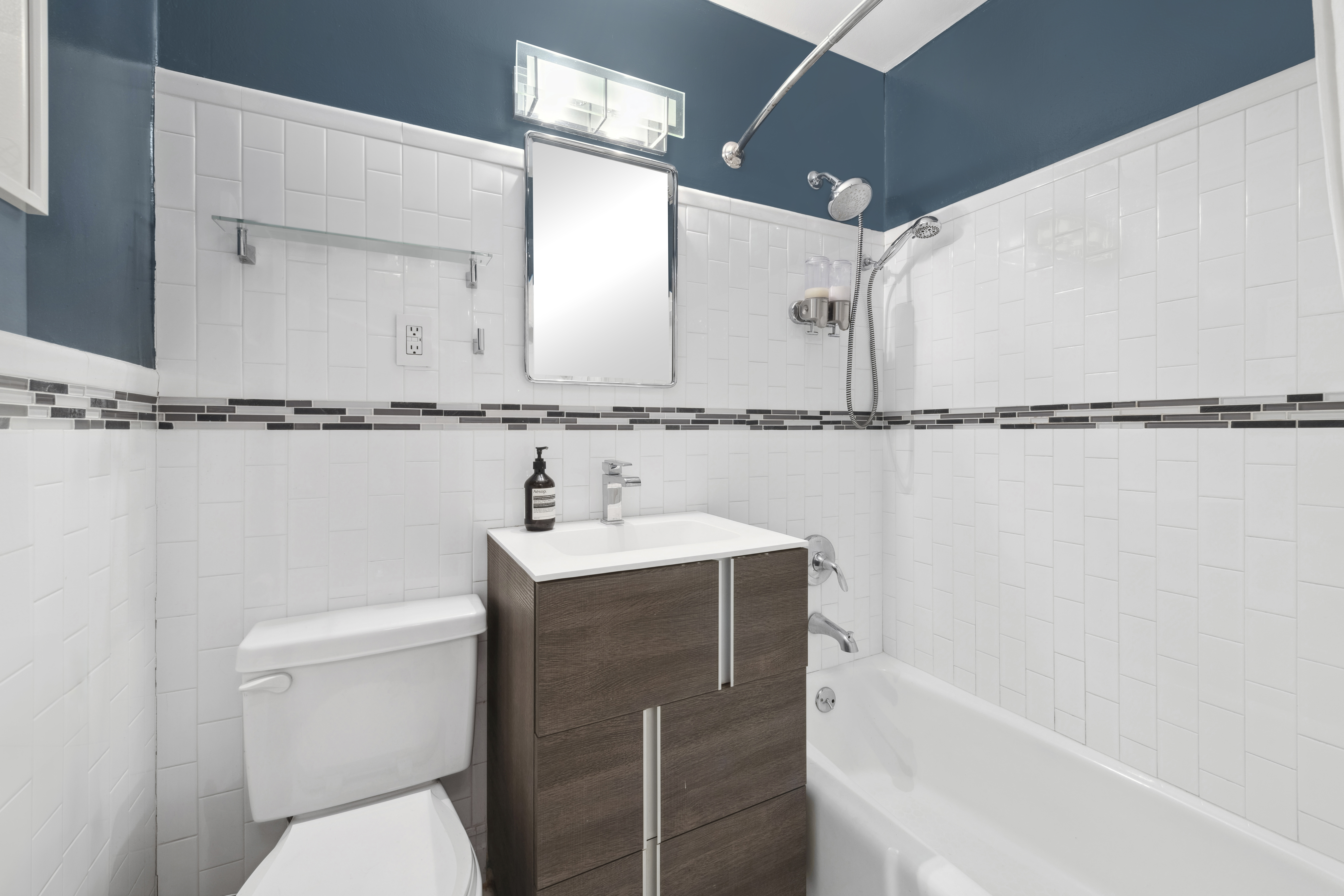 211 Thompson Street, Unit GLD Manhattan, NY 10012 - Photo 7 of 10 a bathroom with a shower sink and mirror