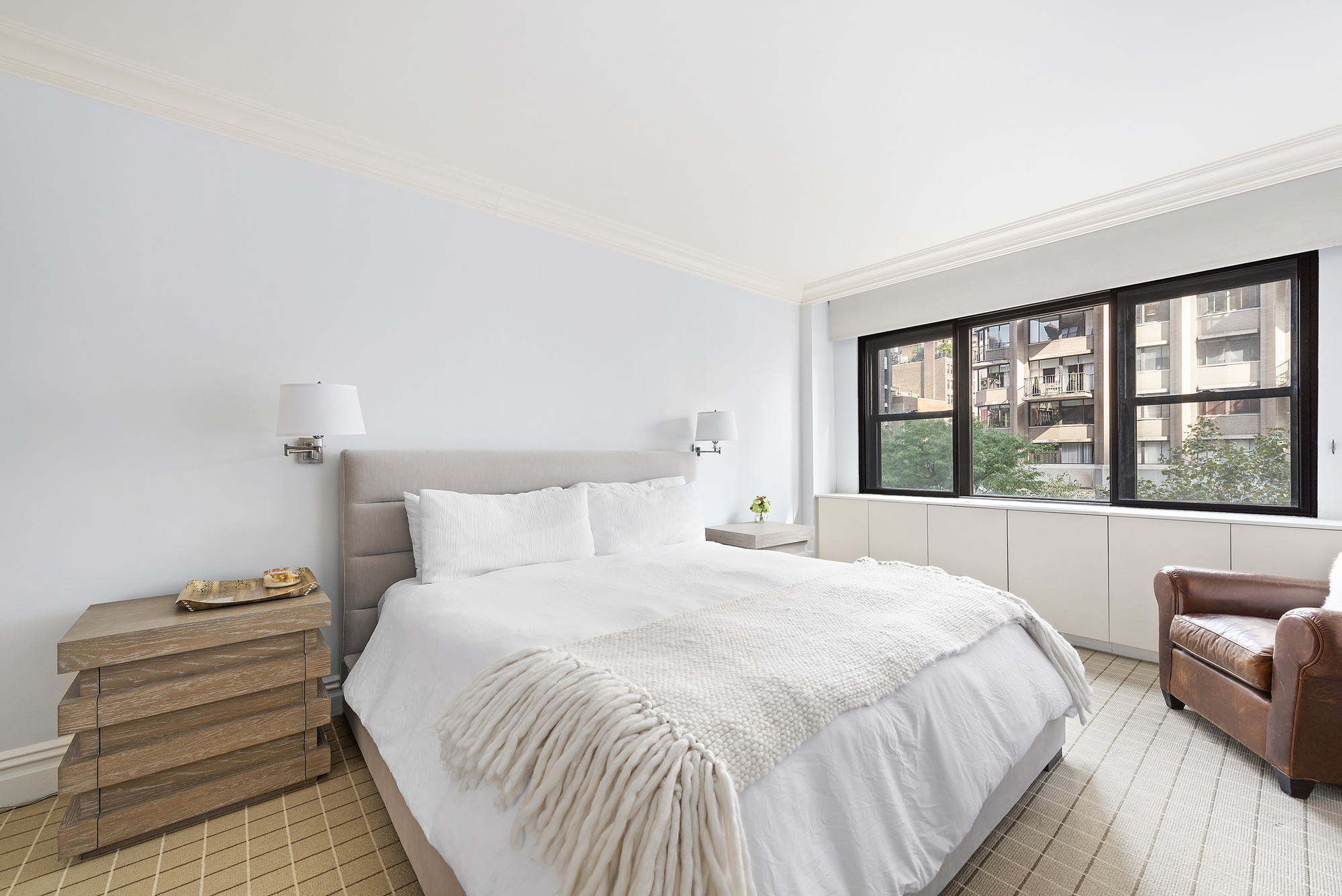 165 East 72nd Street, Unit 3L Manhattan, NY 10021 - Photo 4 of 13 a bedroom with a bed and a large window