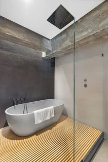 a bathroom with a bathtub and shower
