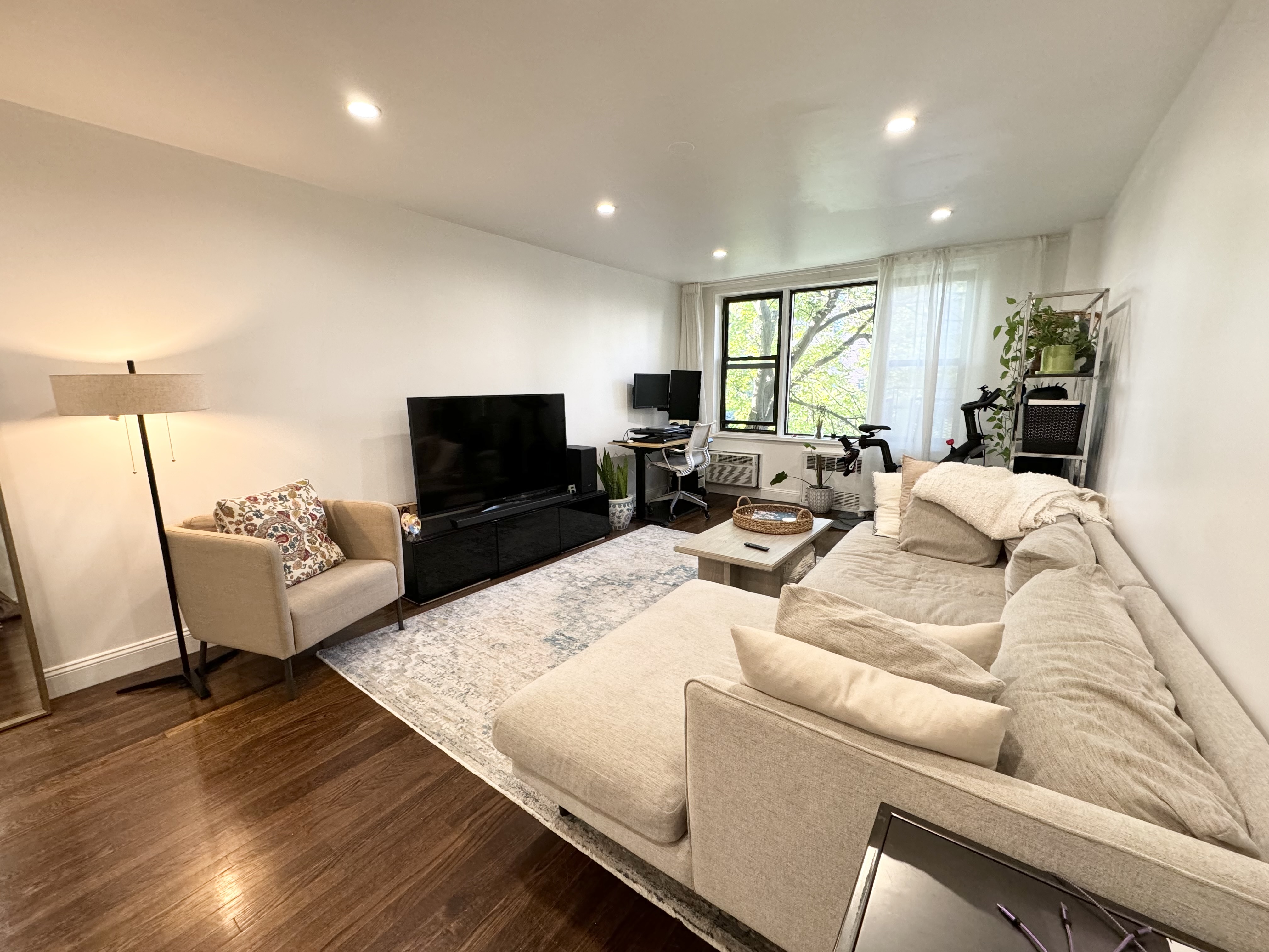 310 Lenox Road, Unit 4D Brooklyn, NY 11226 - Photo 1 of 14 a living room with furniture and a flat screen tv