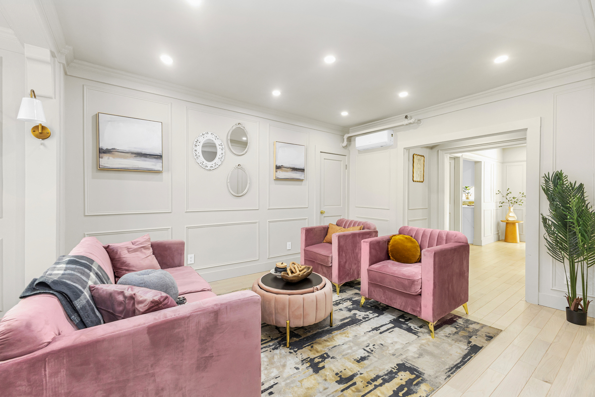 a living room with furniture and a potted plant