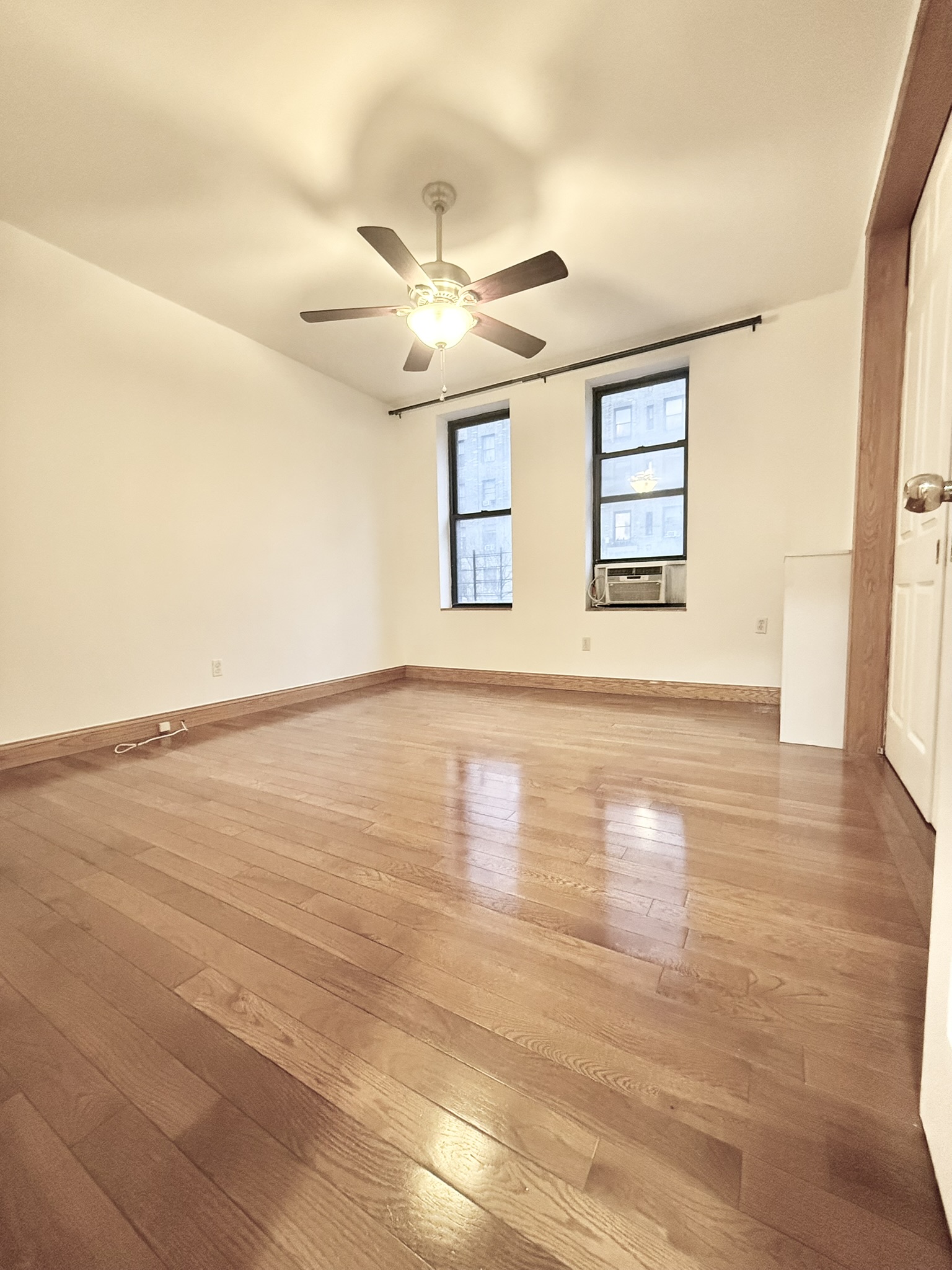 839 West End Avenue, Unit 3D Manhattan, NY 10025 - Photo 4 of 10 a view of an empty room with wooden floor and a window