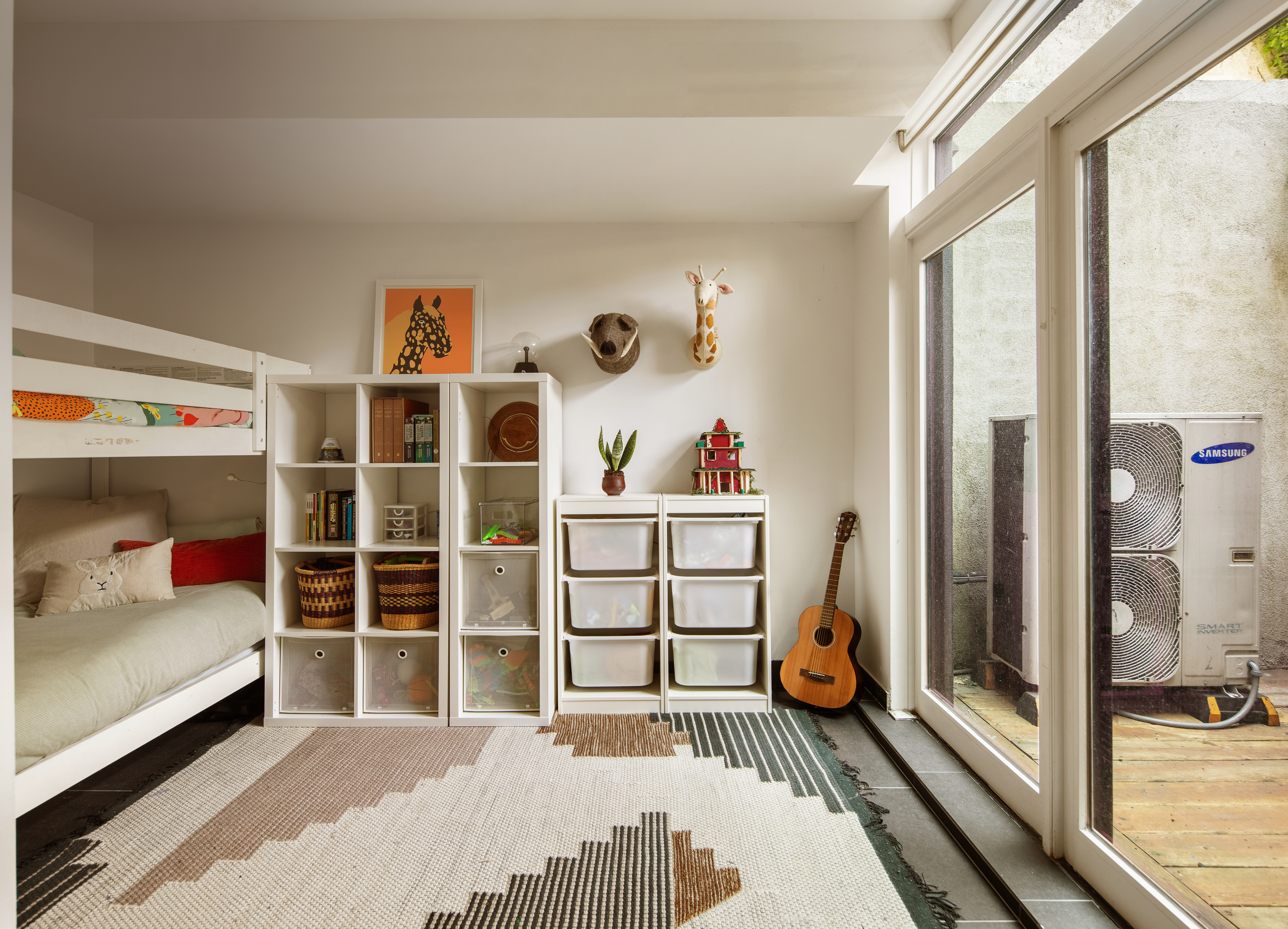 161 Jackson Street, Unit 1 Brooklyn, NY 11211 - Photo 8 of 11 a bedroom with furniture and a book shelf