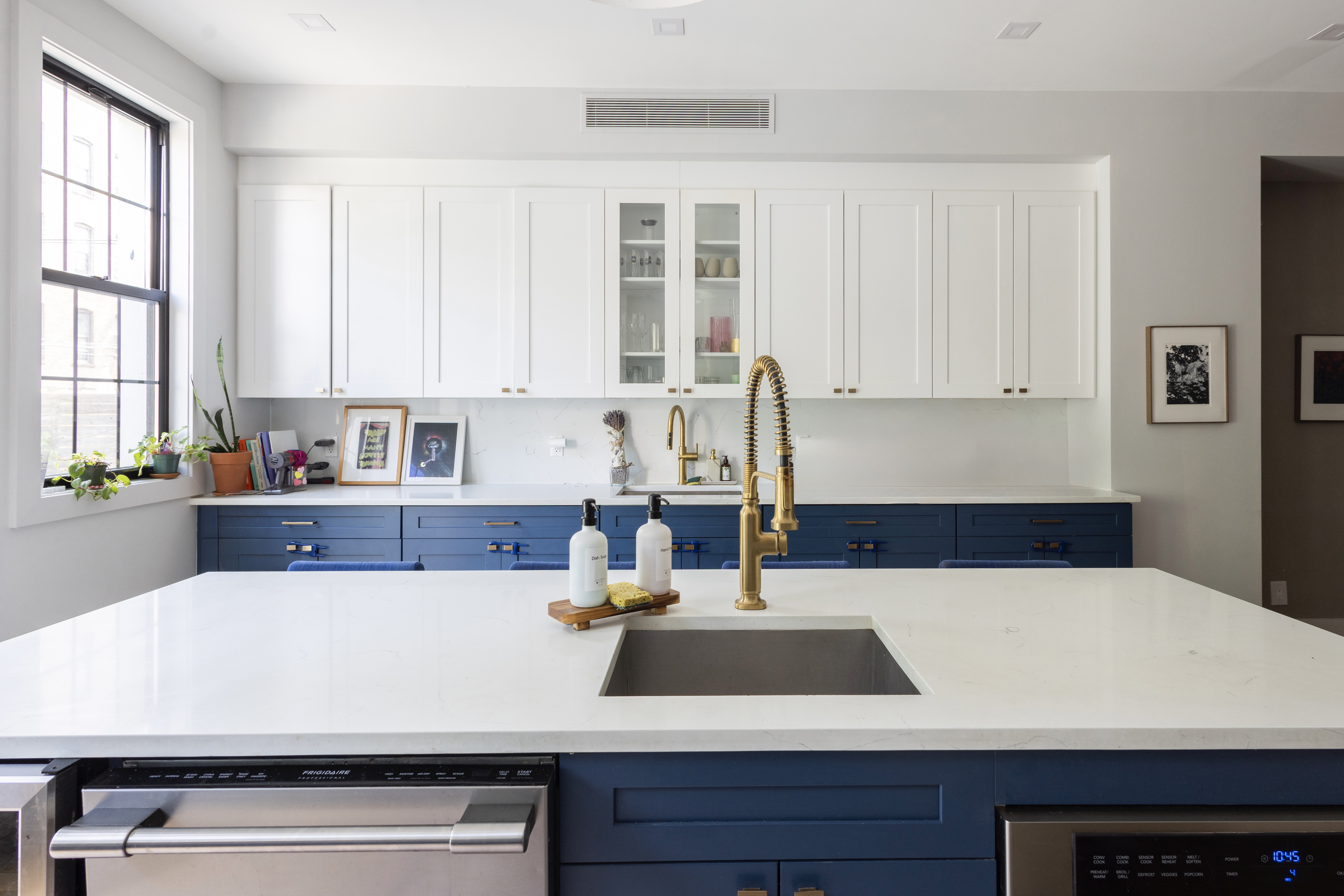 239 Winthrop Street Brooklyn, NY 11225 - Photo 7 of 20 a kitchen with kitchen island a sink a stove and white cabinets