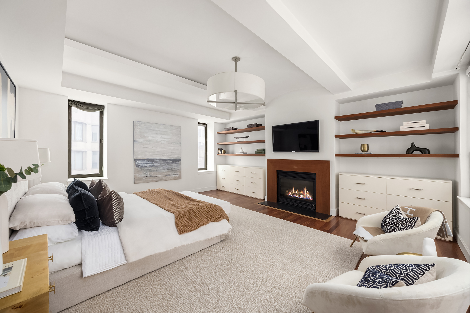 43 West 64th Street, Unit 7A Manhattan, NY 10023 - Photo 11 of 20 a living room with furniture a fireplace and a flat screen tv