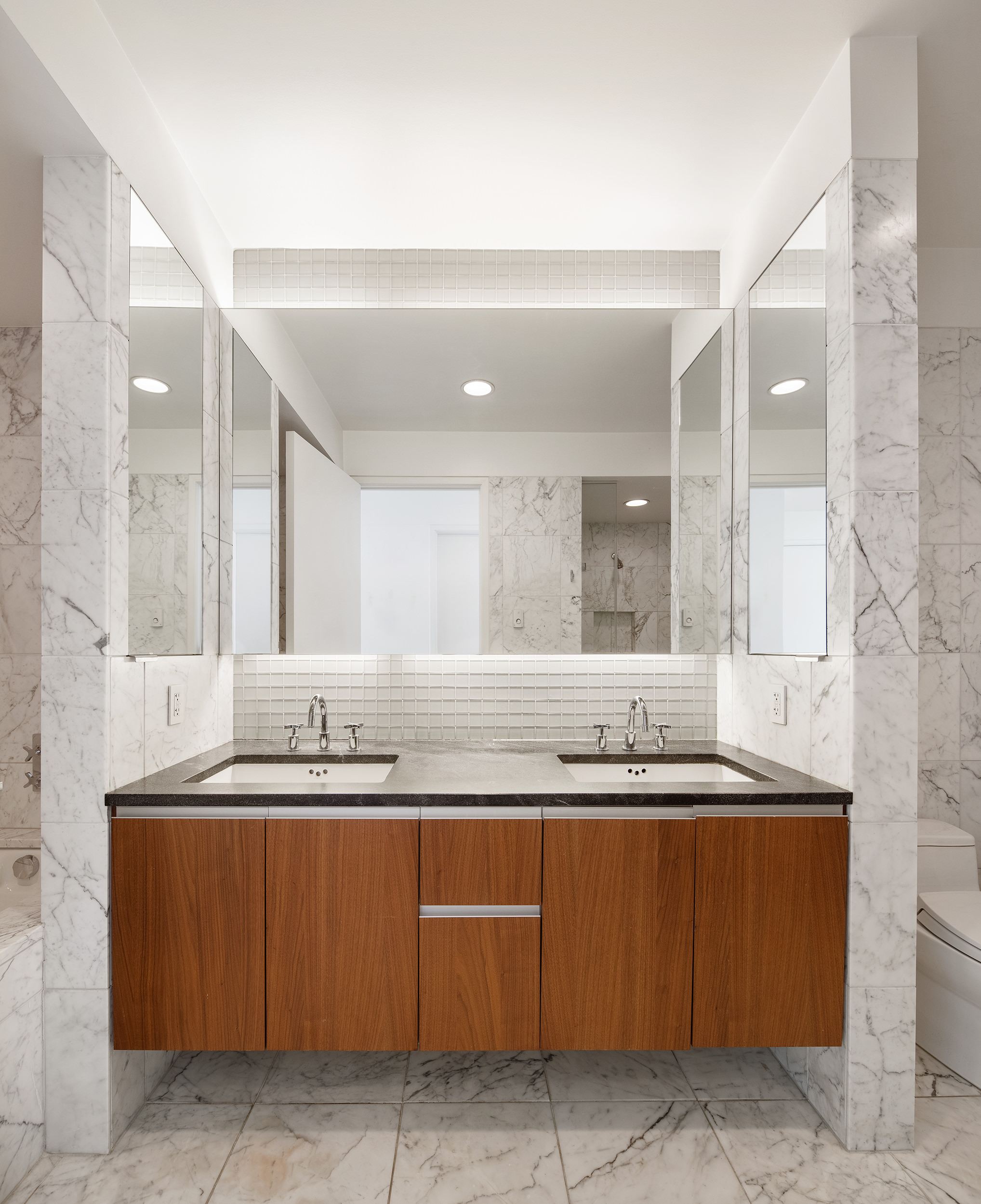 311 West Broadway, Unit 6J Manhattan, NY 10013 - Photo 9 of 19 a bathroom with a granite countertop sink and a mirror