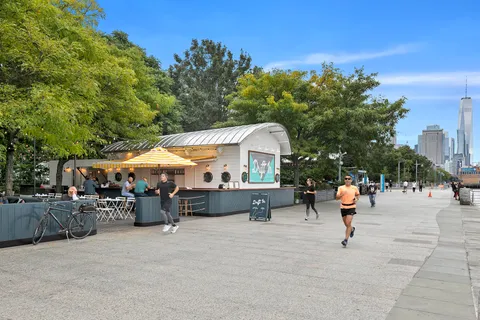 a view of a patio with a table and chairs under an umbrella