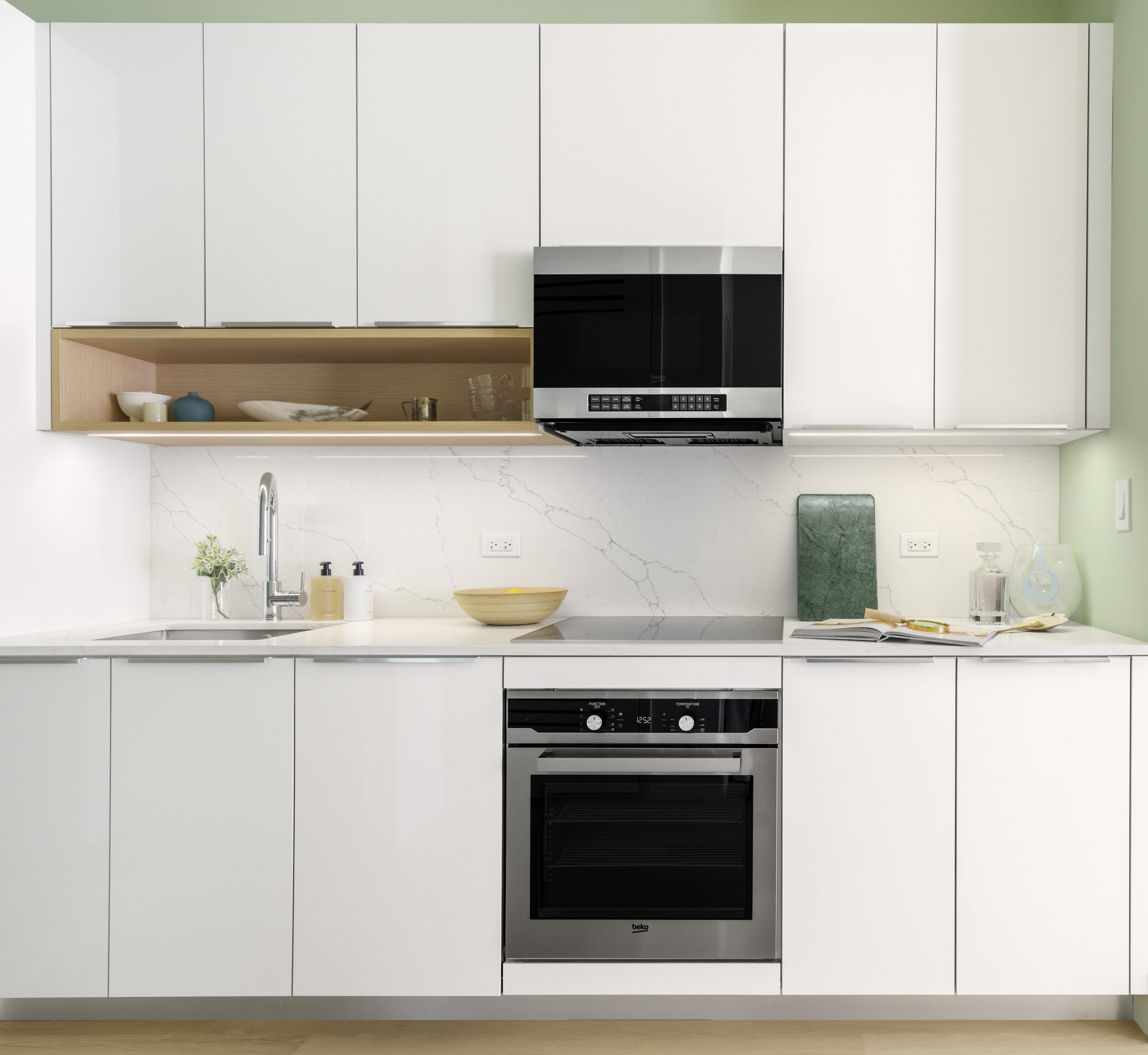 55 Broad Street, Unit 2712 Manhattan, NY 10004 - Photo 2 of 14 a kitchen with stainless steel appliances granite countertop a sink and a microwave