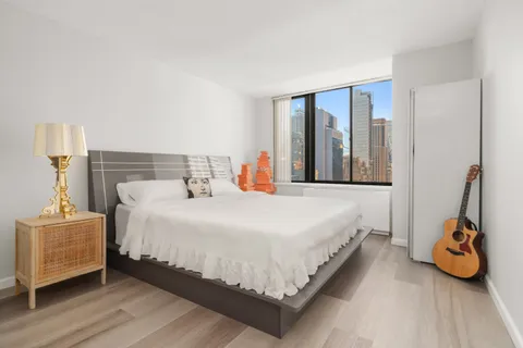 a bedroom with a bed and a window