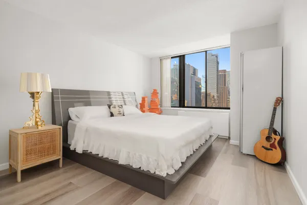 a bedroom with a bed and a window
