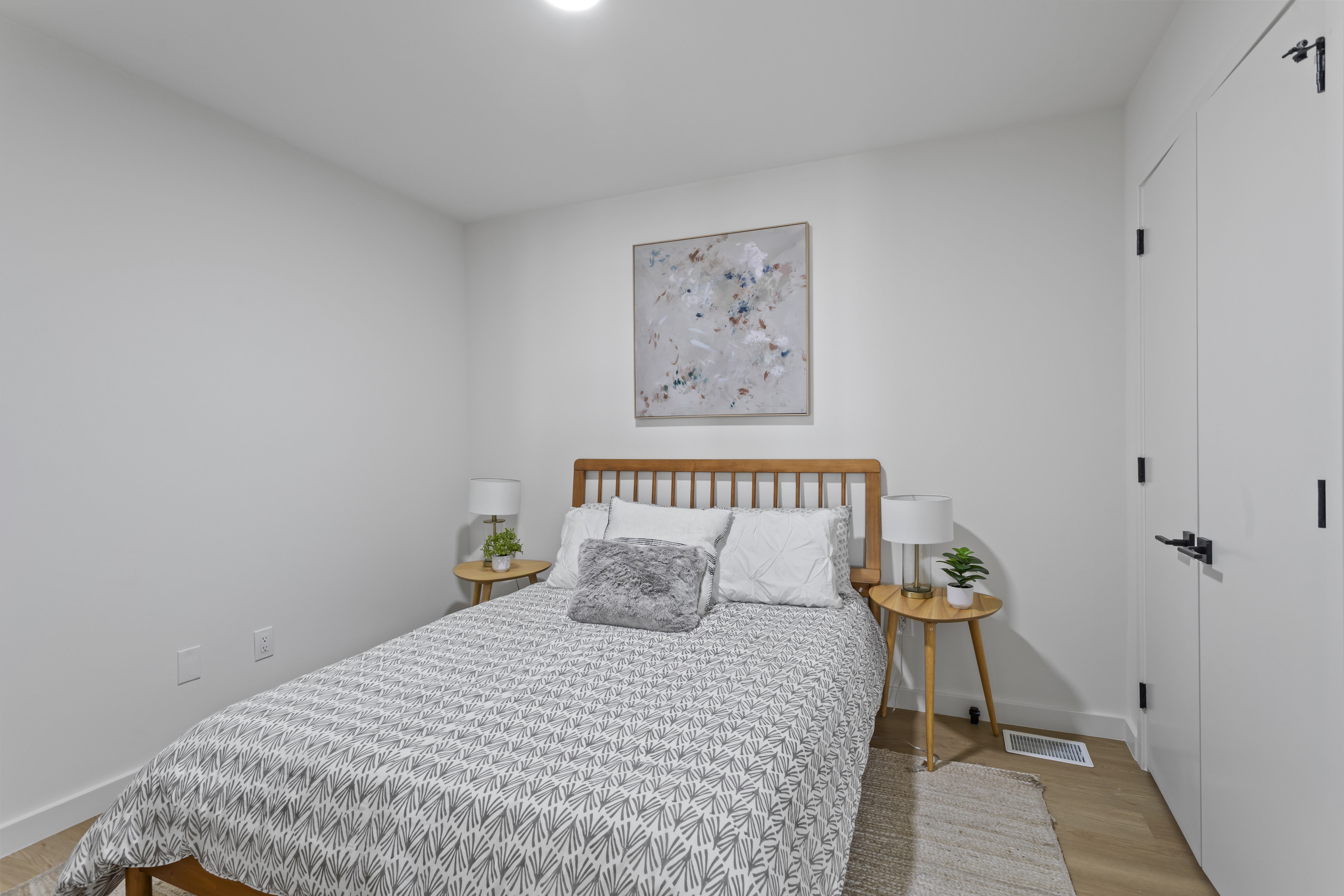 3112 Emmons Avenue, Unit 3124A2 Brooklyn, NY 11235 - Photo 7 of 17 a bedroom with a bed and a painting on the wall