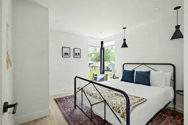 a bedroom with a bed and a window