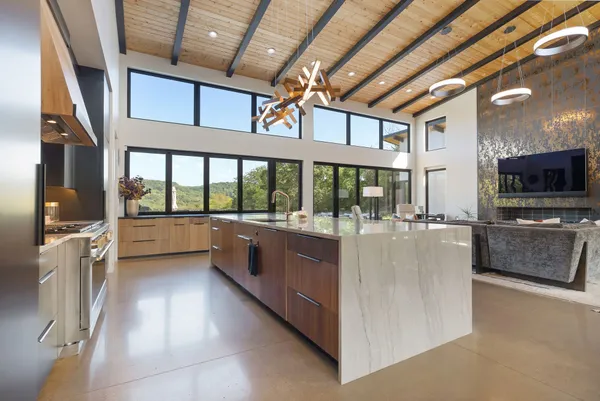 a large kitchen with stainless steel appliances granite countertop a large counter top