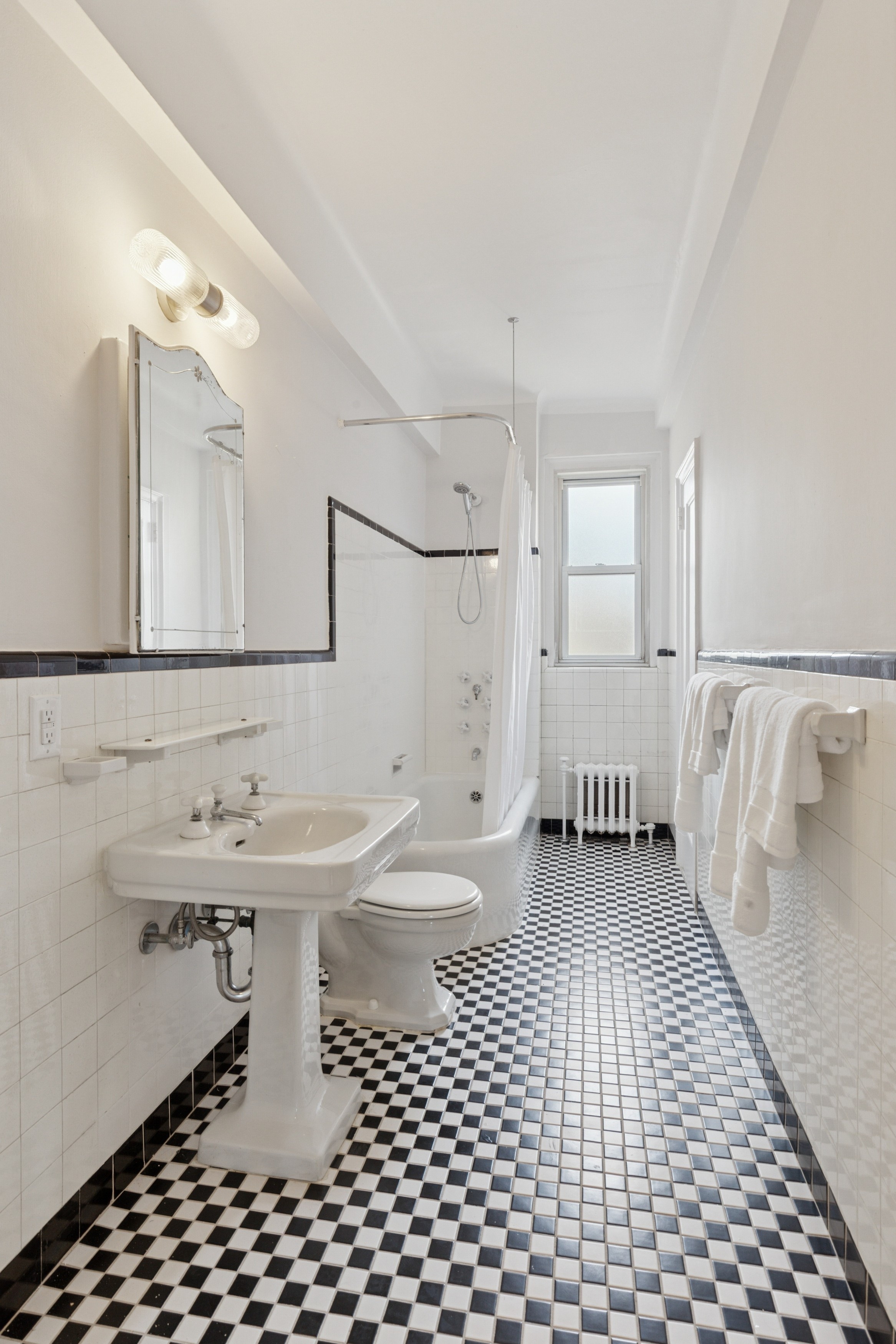 336 Central Park West, Unit 16F Manhattan, NY 10025 - Photo 12 of 18 a bathroom with a sink toilet and shower