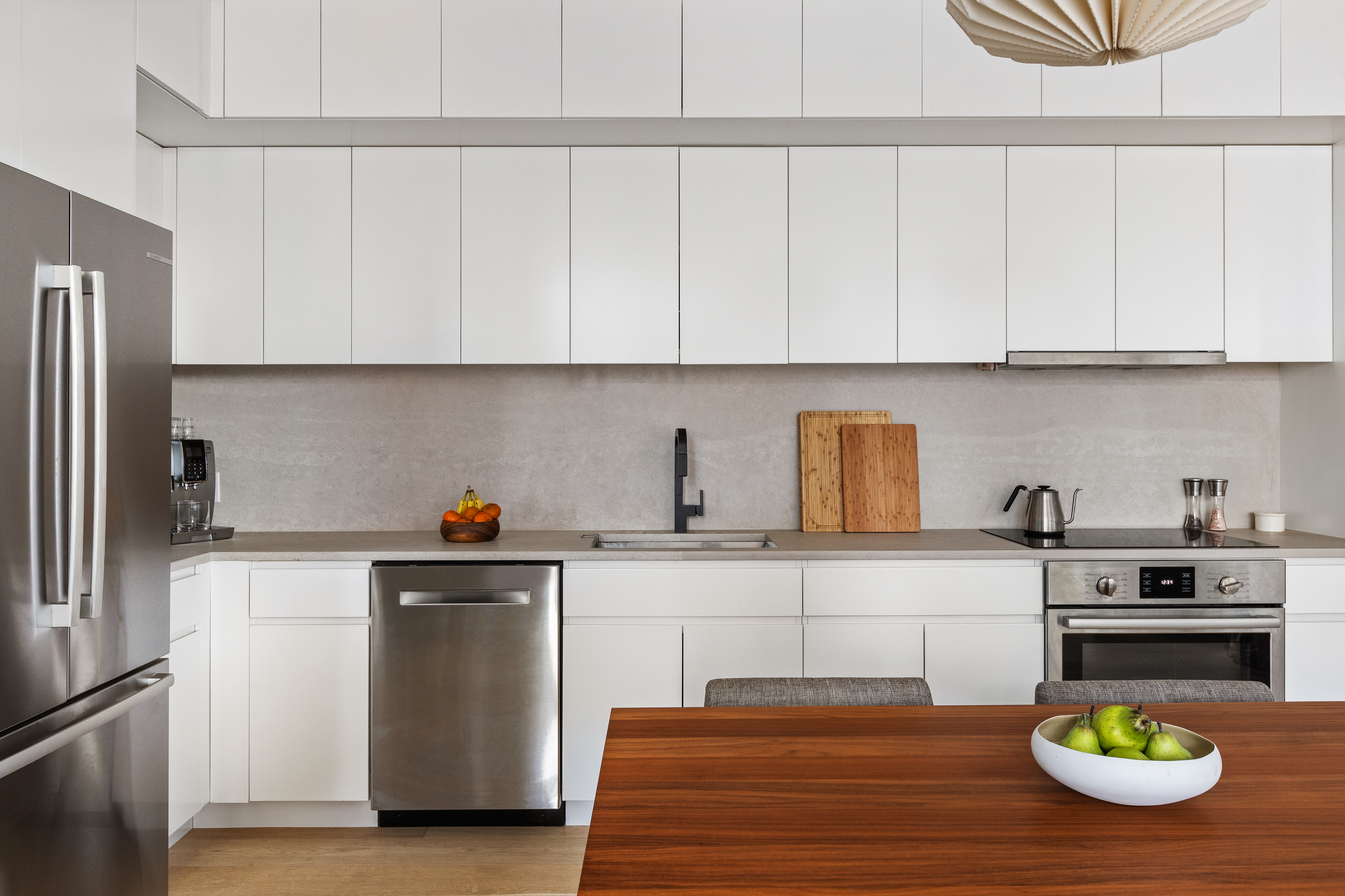 112 Fleet Place, Unit 6A Brooklyn, NY 11201 - Photo 5 of 11 a kitchen with white cabinets and appliances