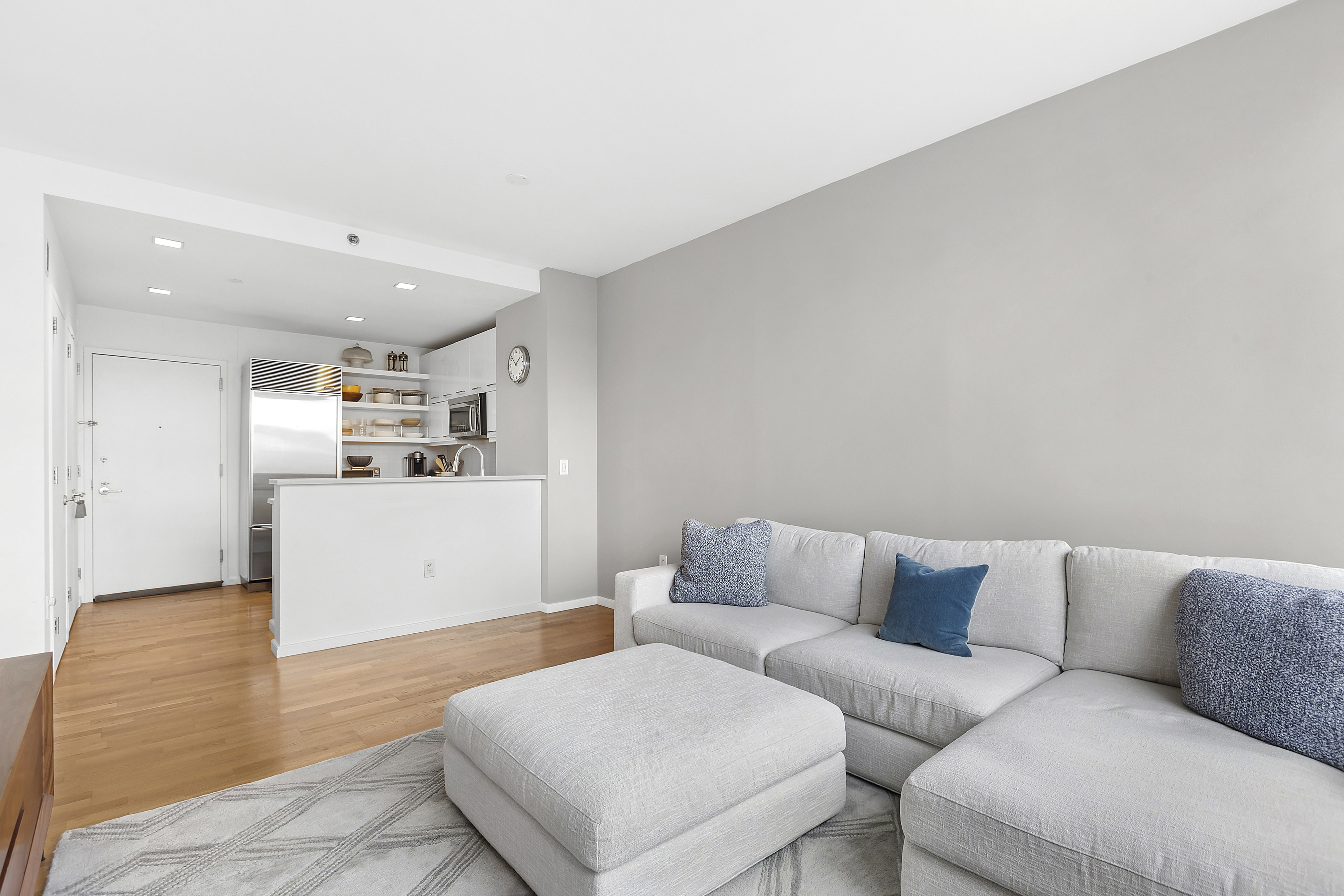 635 West 42nd Street, Unit 4B Manhattan, NY 10036 - Photo 2 of 11 a living room with furniture and kitchen view