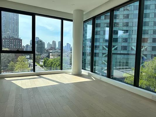 4507 Court Square, Unit 8D Queens, NY 11101 - Photo 26 of 28 a view of an empty room with wooden floor and a window