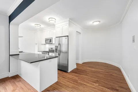 a kitchen with stainless steel appliances granite countertop a sink and a refrigerator