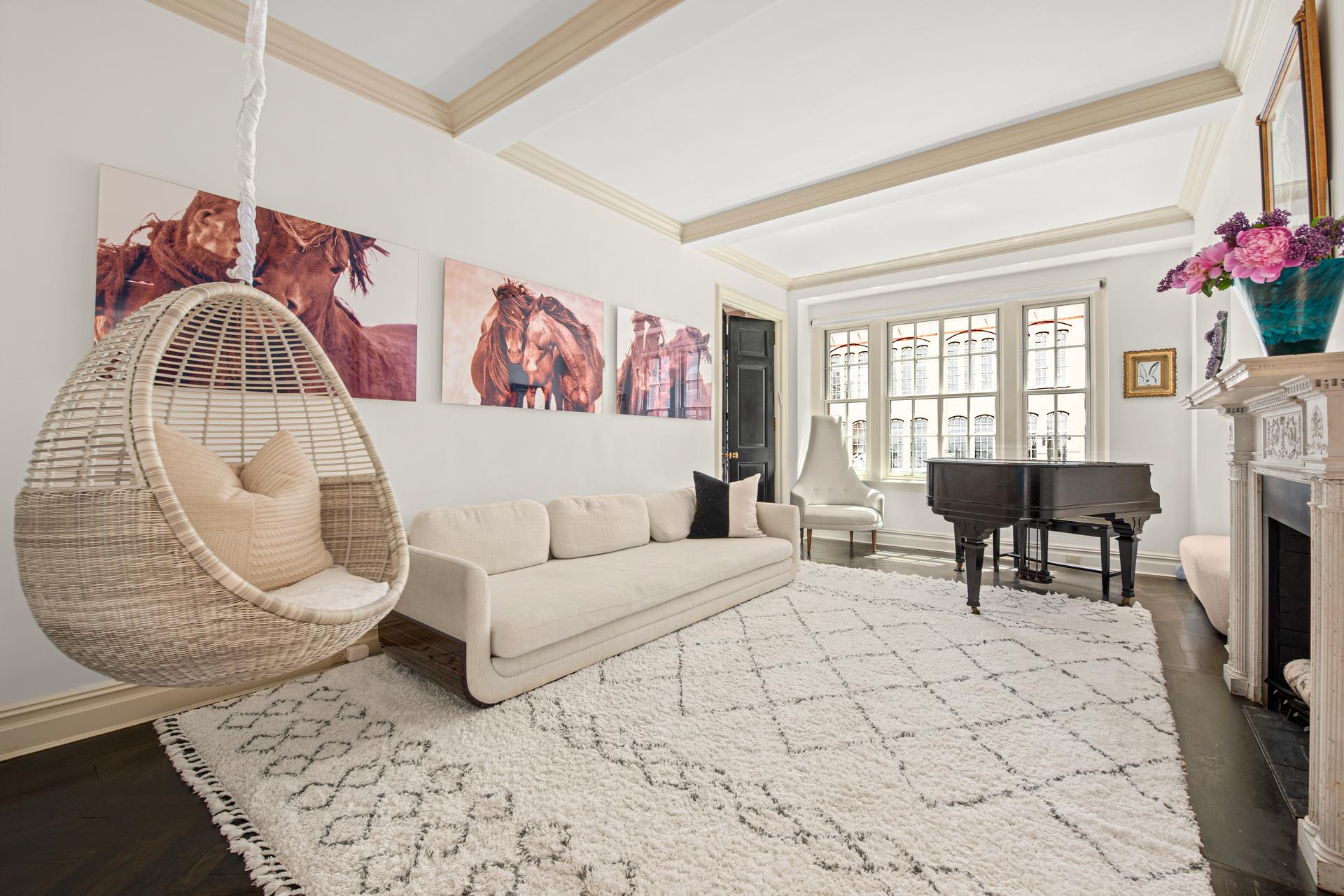 1140 5th Avenue, Unit 8C Manhattan, NY 10128 - Photo 2 of 16 a living room with furniture and a fireplace