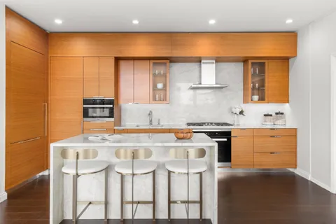 a kitchen with stainless steel appliances granite countertop a stove a sink and a refrigerator
