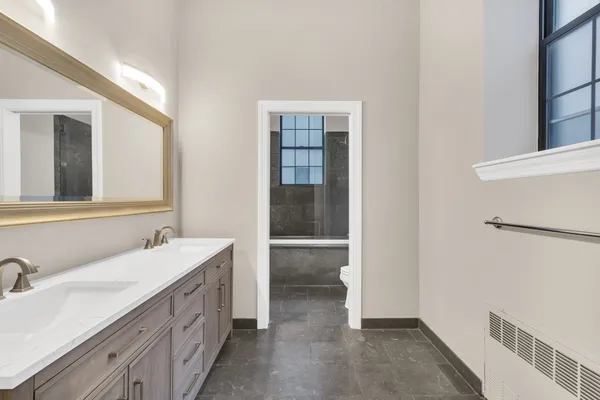 a bathroom with a double vanity sink and a mirror