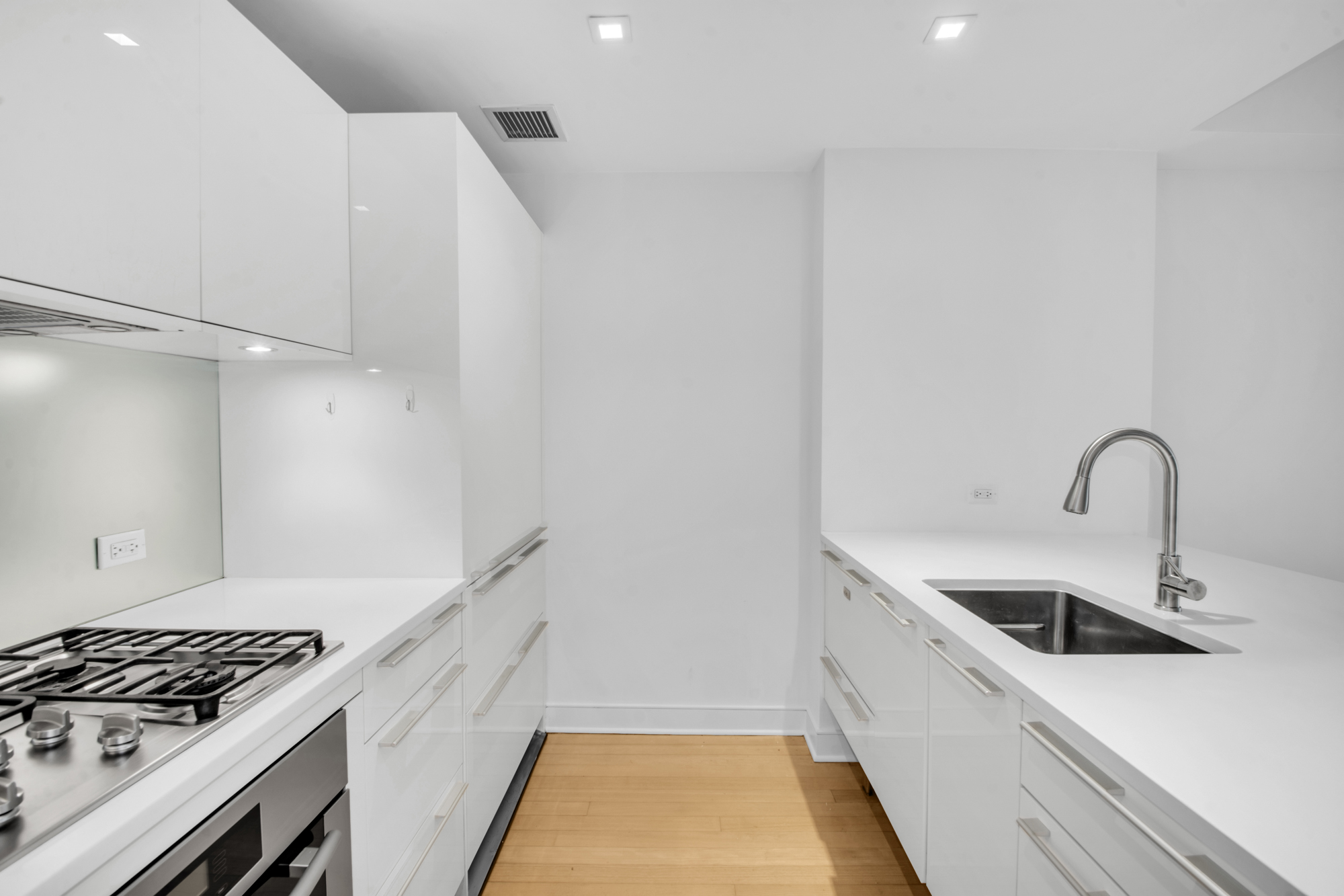 5 East 44th Street, Unit 5A Manhattan, NY 10017 - Photo 9 of 15 a kitchen with sink a stove and cabinets