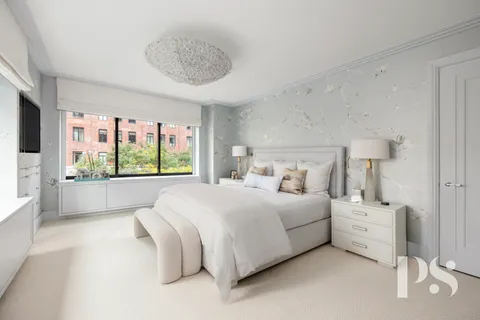 a bedroom with a large bed and a large window