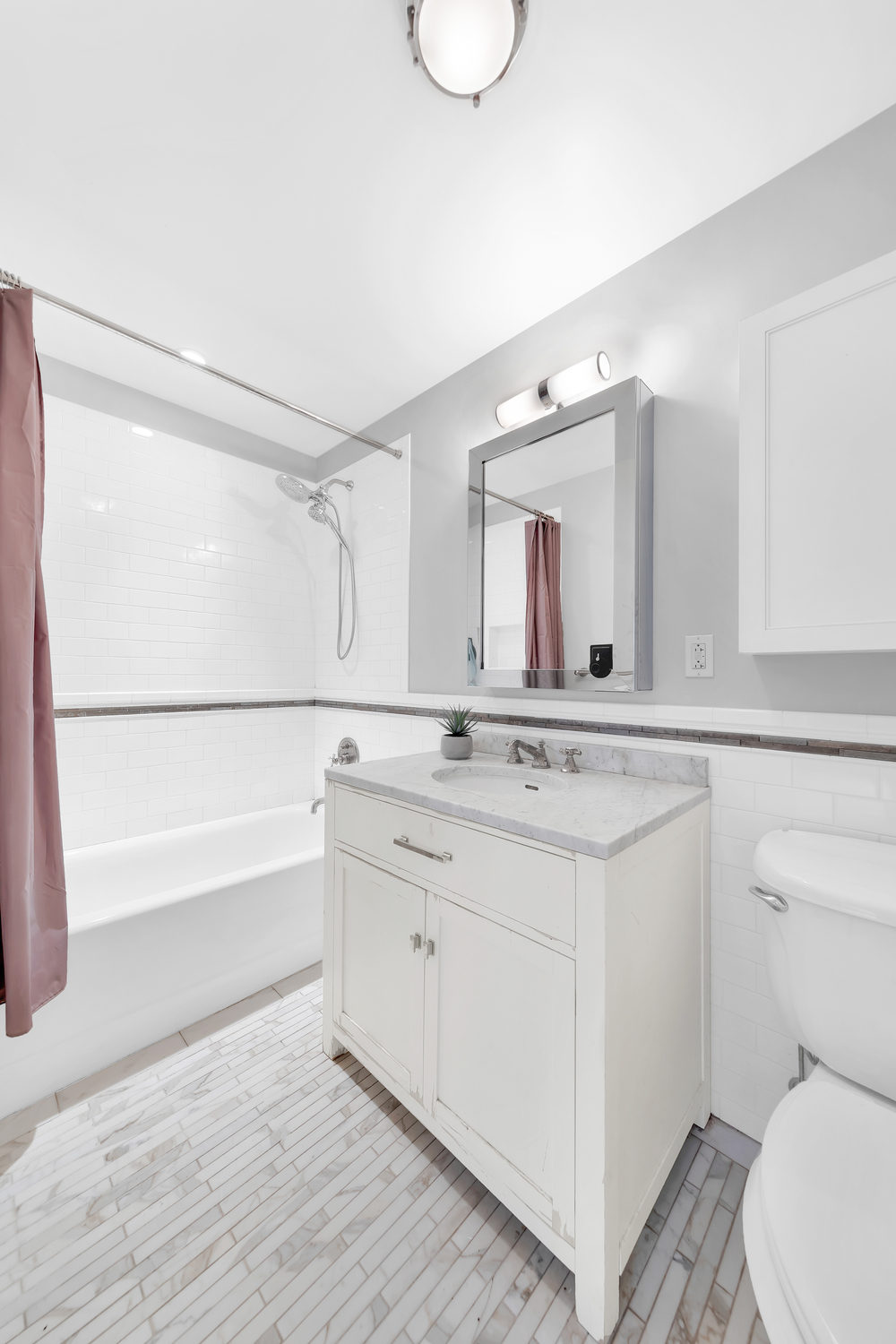 610 West 110th Street, Unit 8AB Manhattan, NY 10025 - Photo 11 of 14 a bathroom with a granite countertop sink mirror vanity and toilet