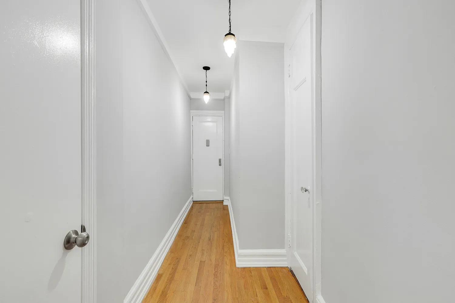 a view of a room with wooden floor and shower