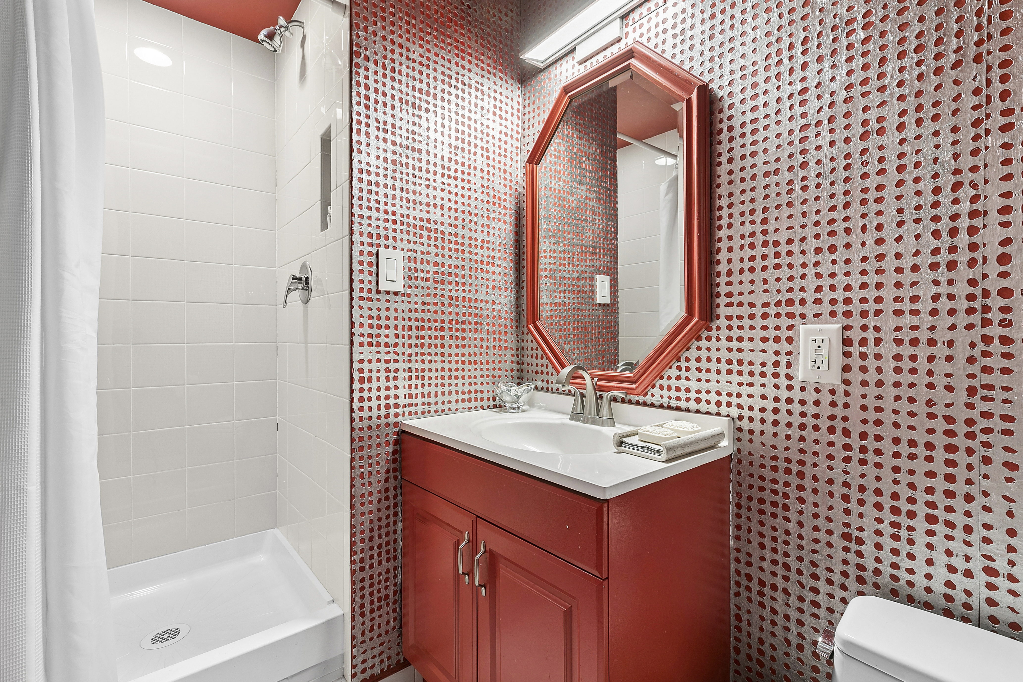 1065 Park Avenue, Unit 4BC Manhattan, NY 10128 - Photo 10 of 16 a bathroom with a sink a toilet and shower