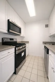 a kitchen with granite countertop a stove and a microwave