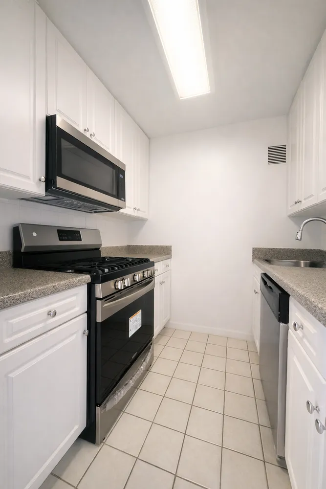 a kitchen with granite countertop a stove and a microwave