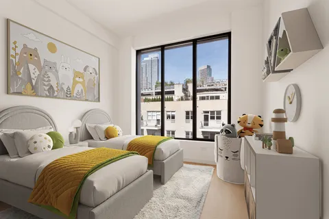 a bedroom with two beds and a large window