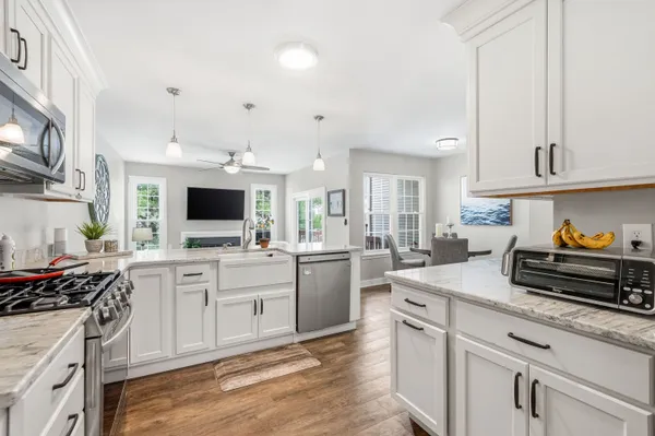 a kitchen with a sink stove and cabinets