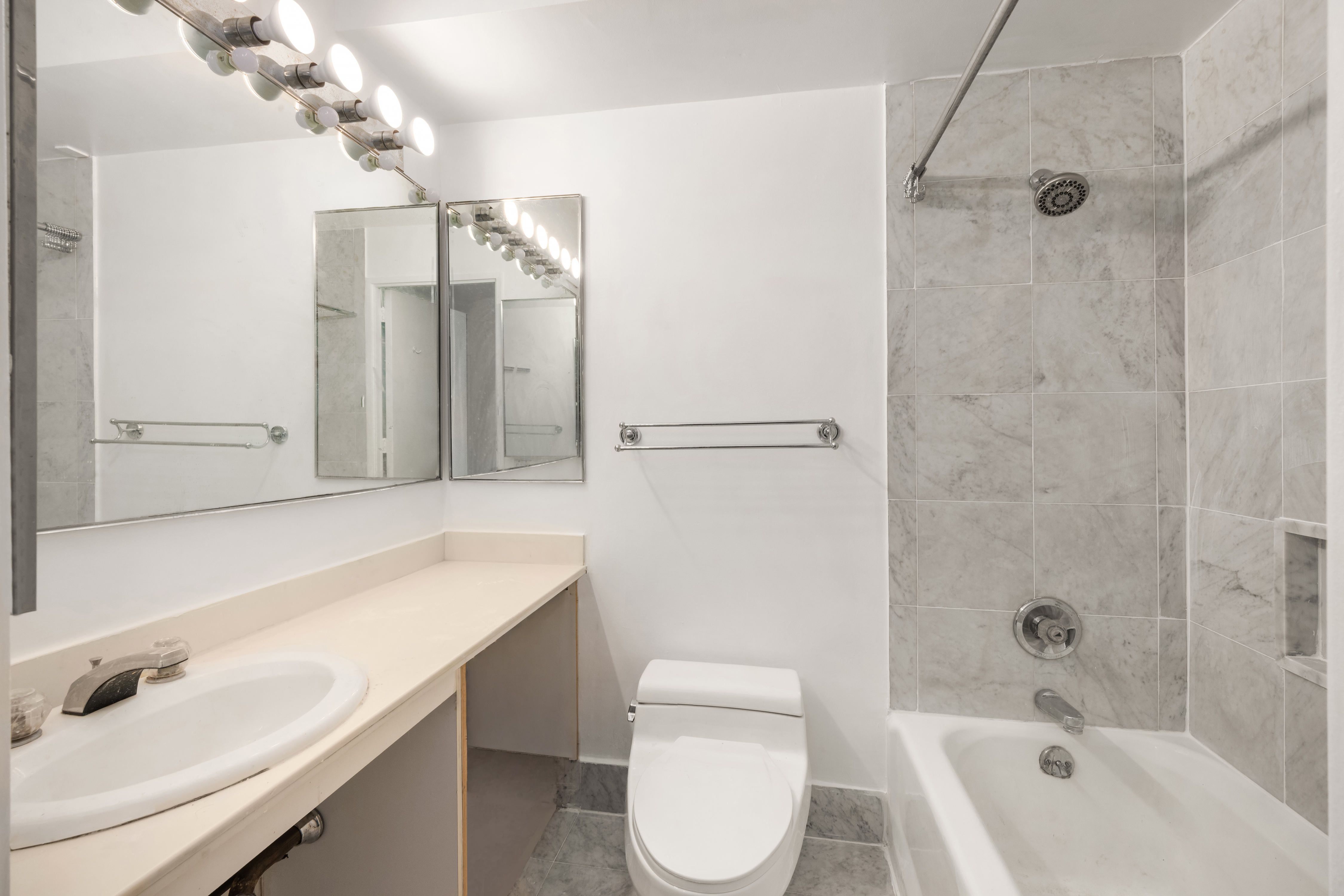 330 East 38th Street, Unit 22H Manhattan, NY 10016 - Photo 10 of 11 a bathroom with a sink a toilet and shower