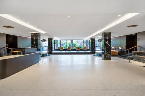 a view of a living room and kitchen with furniture and a flat screen tv