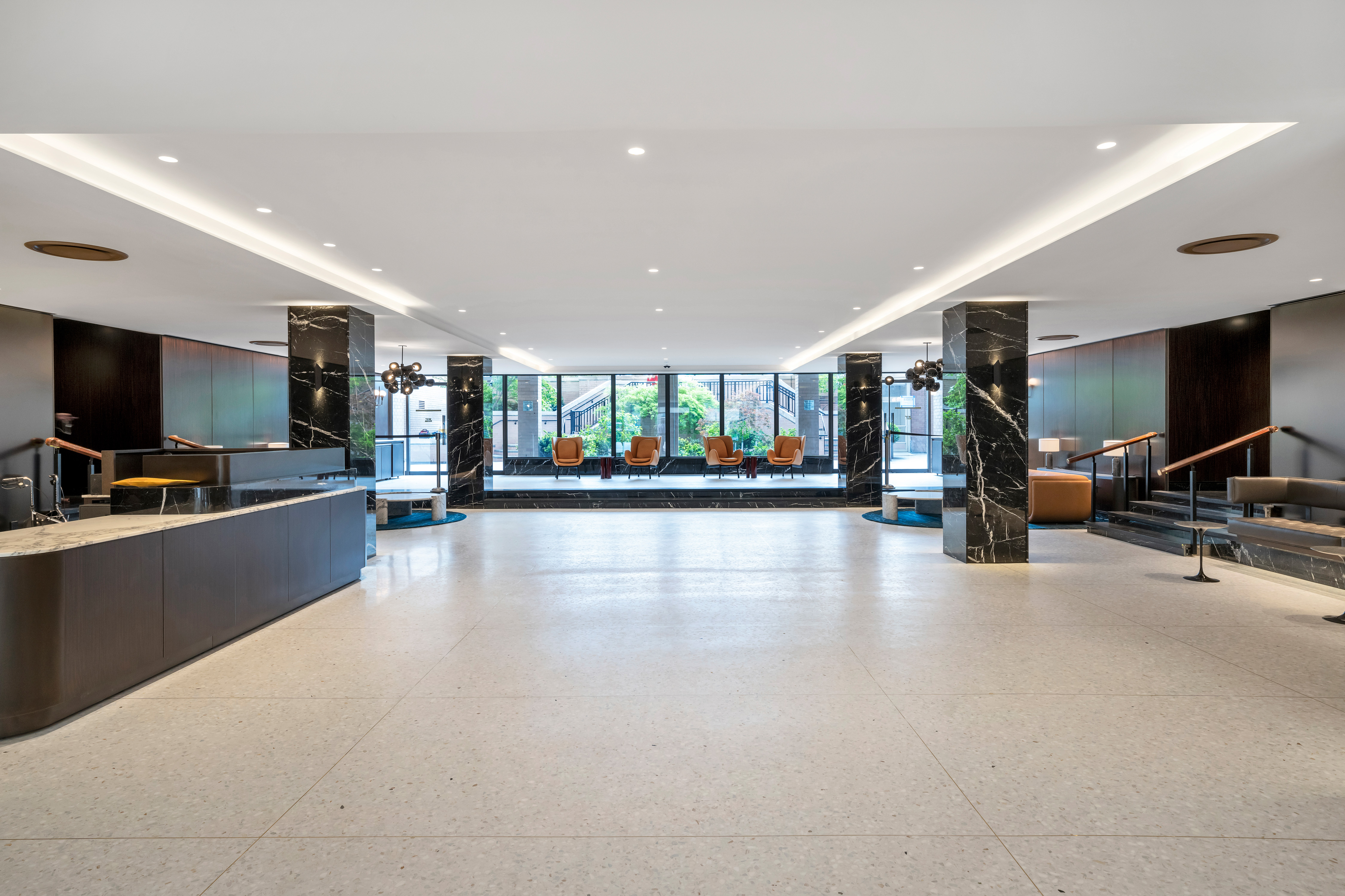 25 Sutton Place South, Unit 8G Manhattan, NY 10022 - Photo 18 of 22 a view of a living room and kitchen with furniture and a flat screen tv