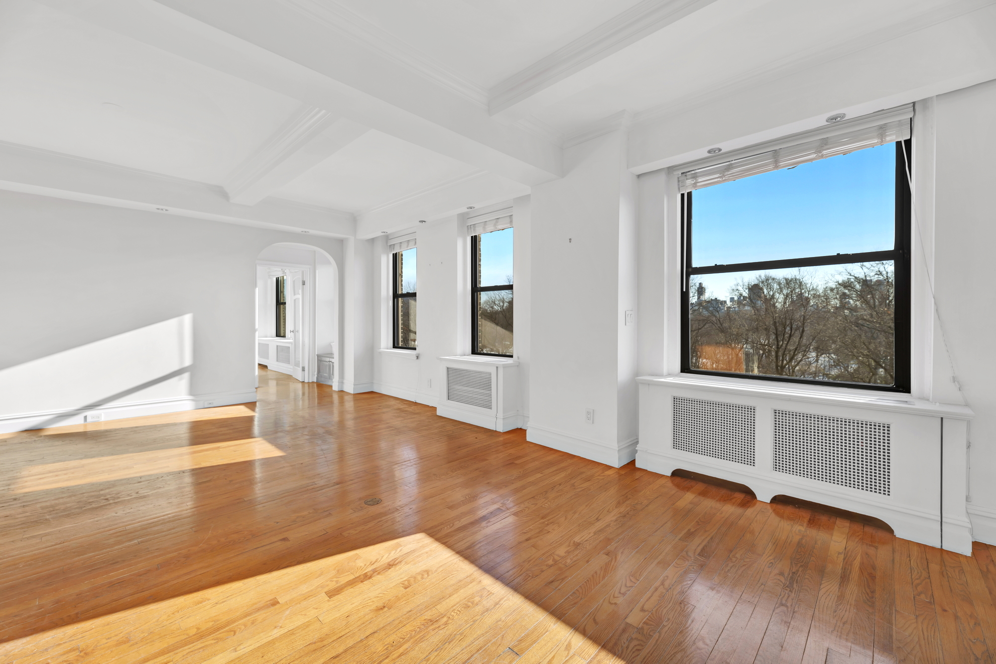 225 Central Park West, Unit 801 Manhattan, NY 10024 - Photo 10 of 21 a view of an empty room with wooden floor and a window