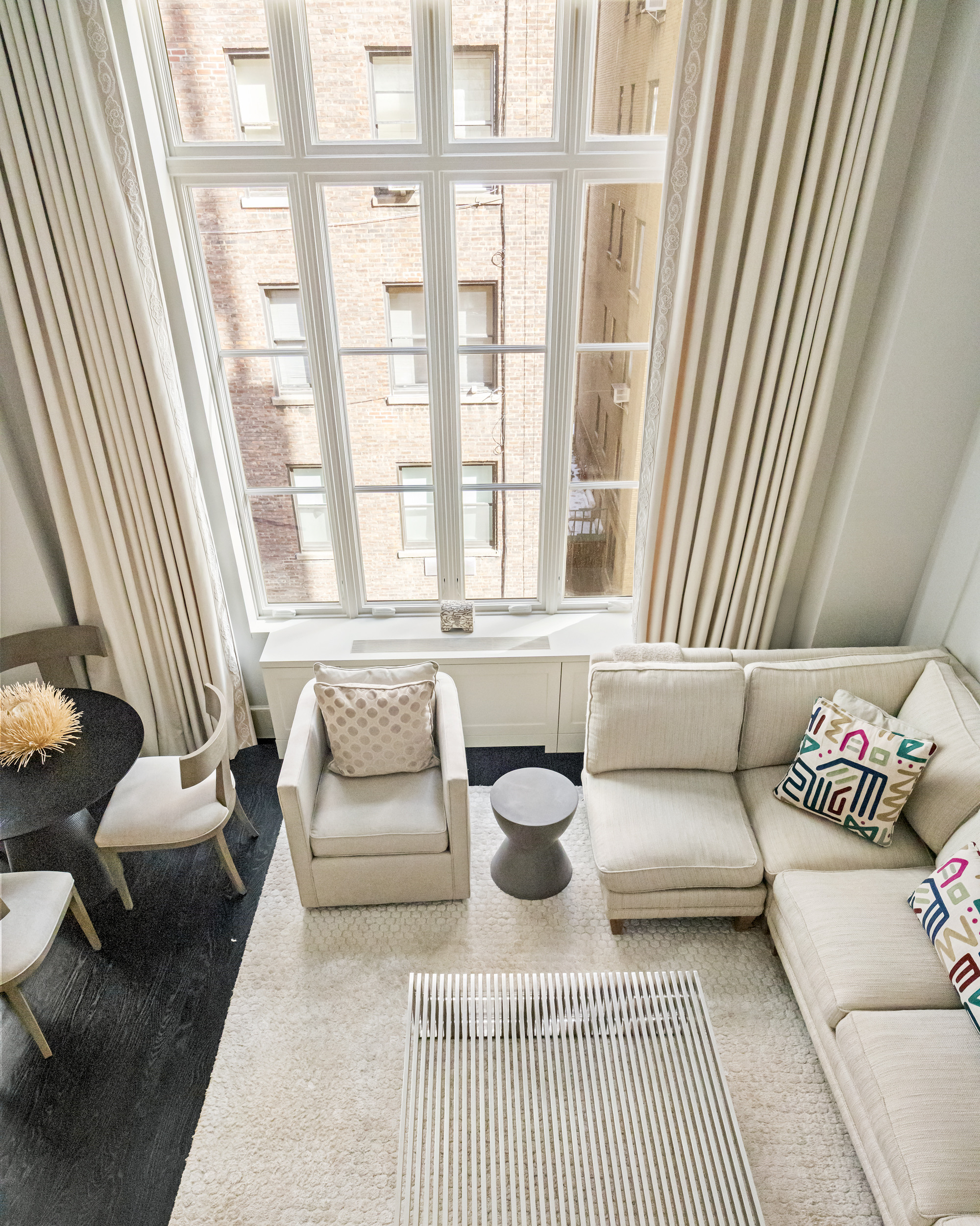 169 East 78th Street, Unit 7C Manhattan, NY 10075 - Photo 24 of 30 a living room with furniture and a large window