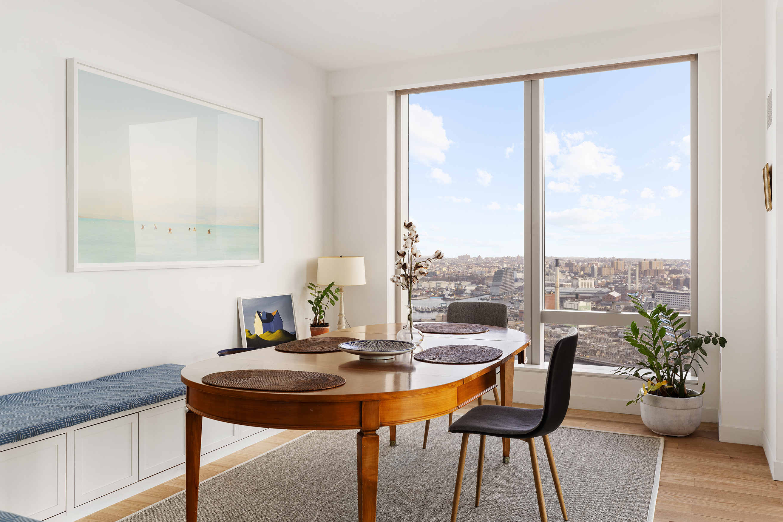 252 South Street, Unit 43C Manhattan, NY 10002 - Photo 3 of 10 a view of a dining room with furniture and wooden floor