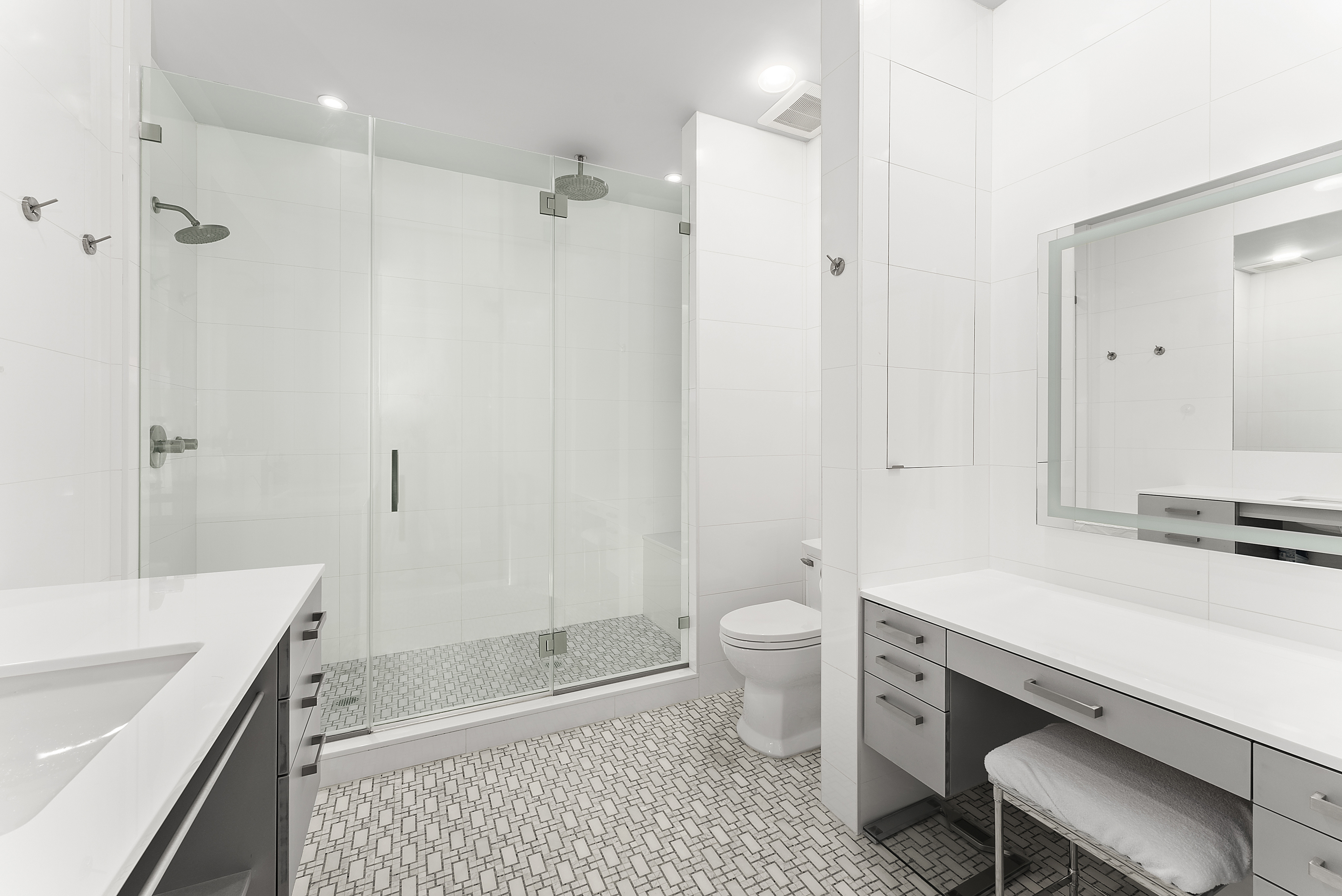 66 Leonard Street, Unit 2A Manhattan, NY 10013 - Photo 10 of 15 a bathroom with a sink a toilet a tub and shower