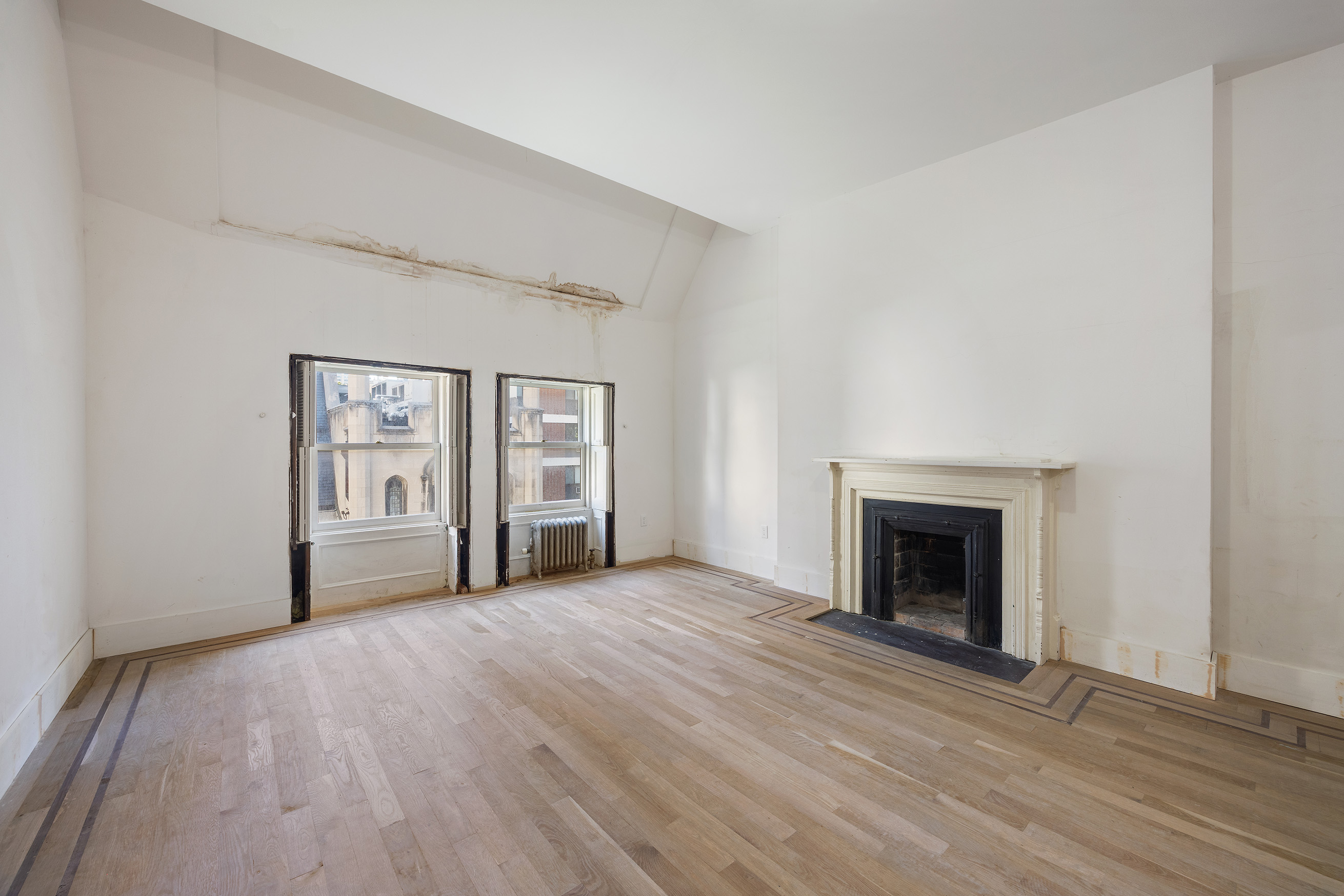 38 East 73rd Street Manhattan, NY 10021 - Photo 15 of 25 a view of an empty room with window and wooden floor